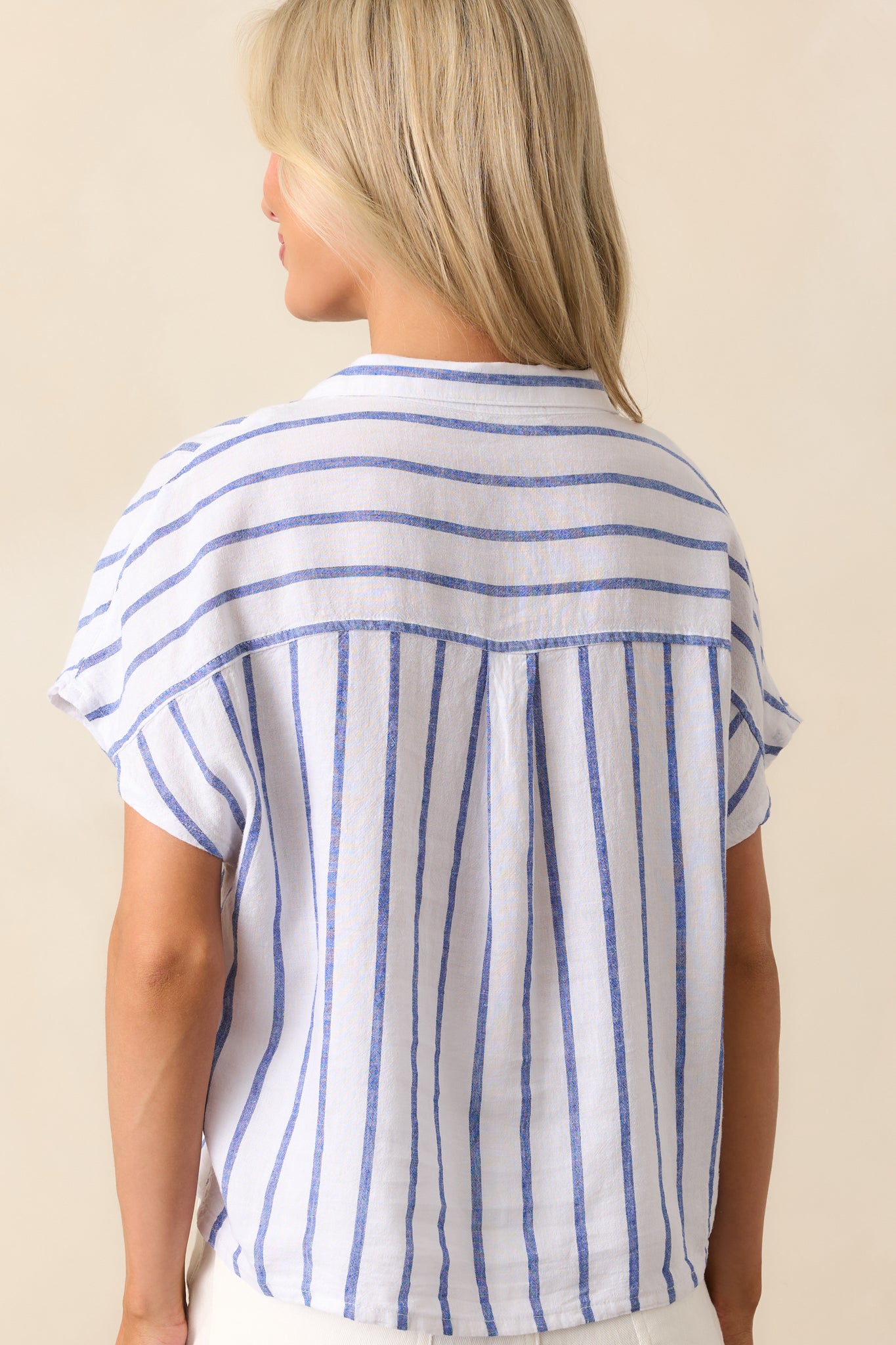Back view of the striped top, displaying the blue and white stripes continuing across the back and the relaxed, straight fit.