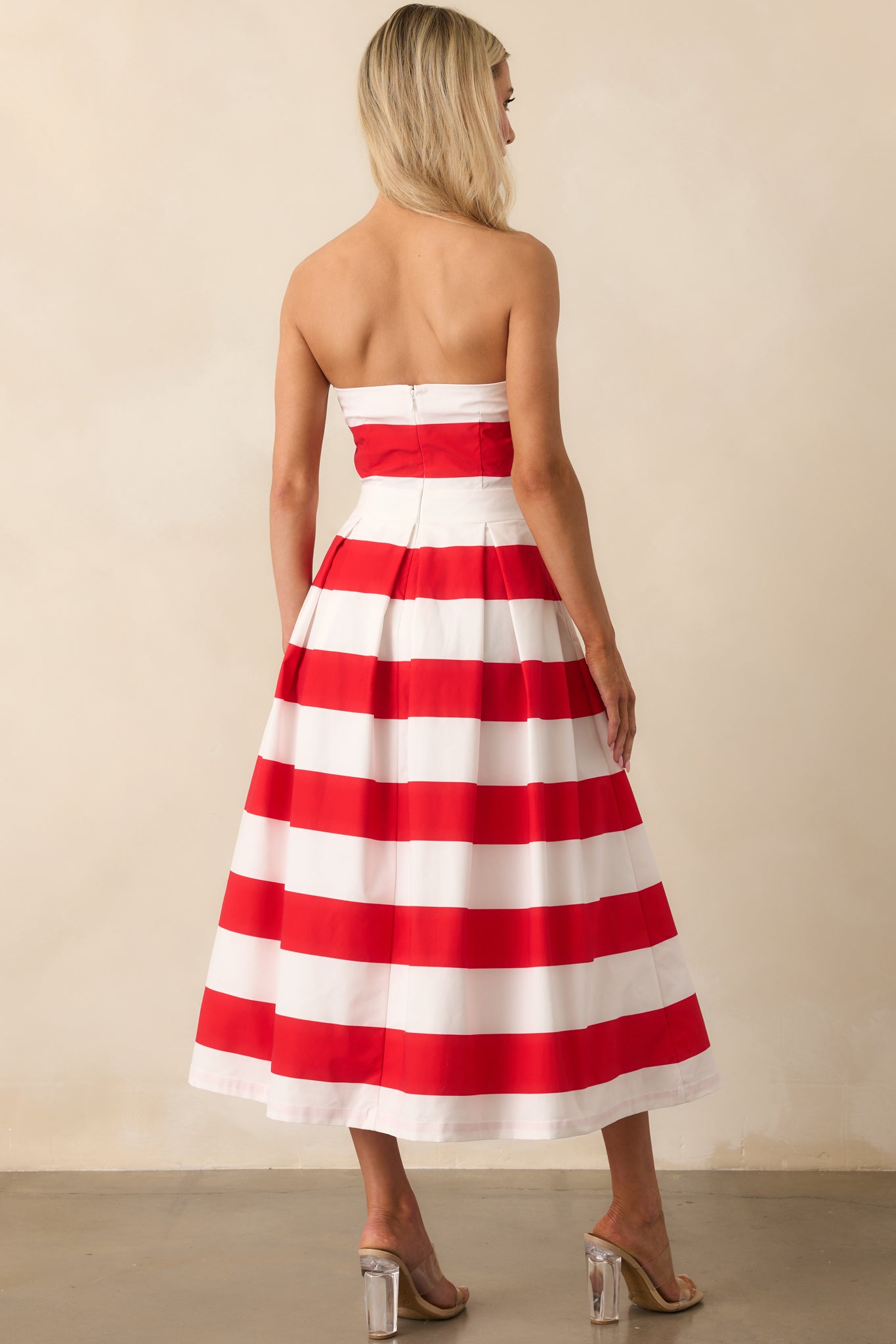 A back view of the strapless dress displaying the hidden back zipper and continued stripe pattern alignment.
