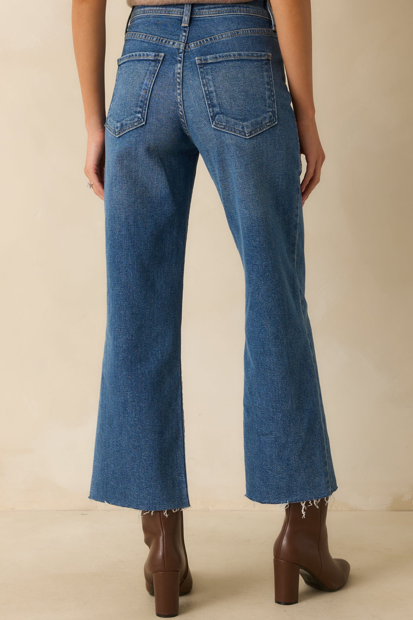 Back view of the utility jeans showing back pockets, high-rise waist, and wide-leg cut.