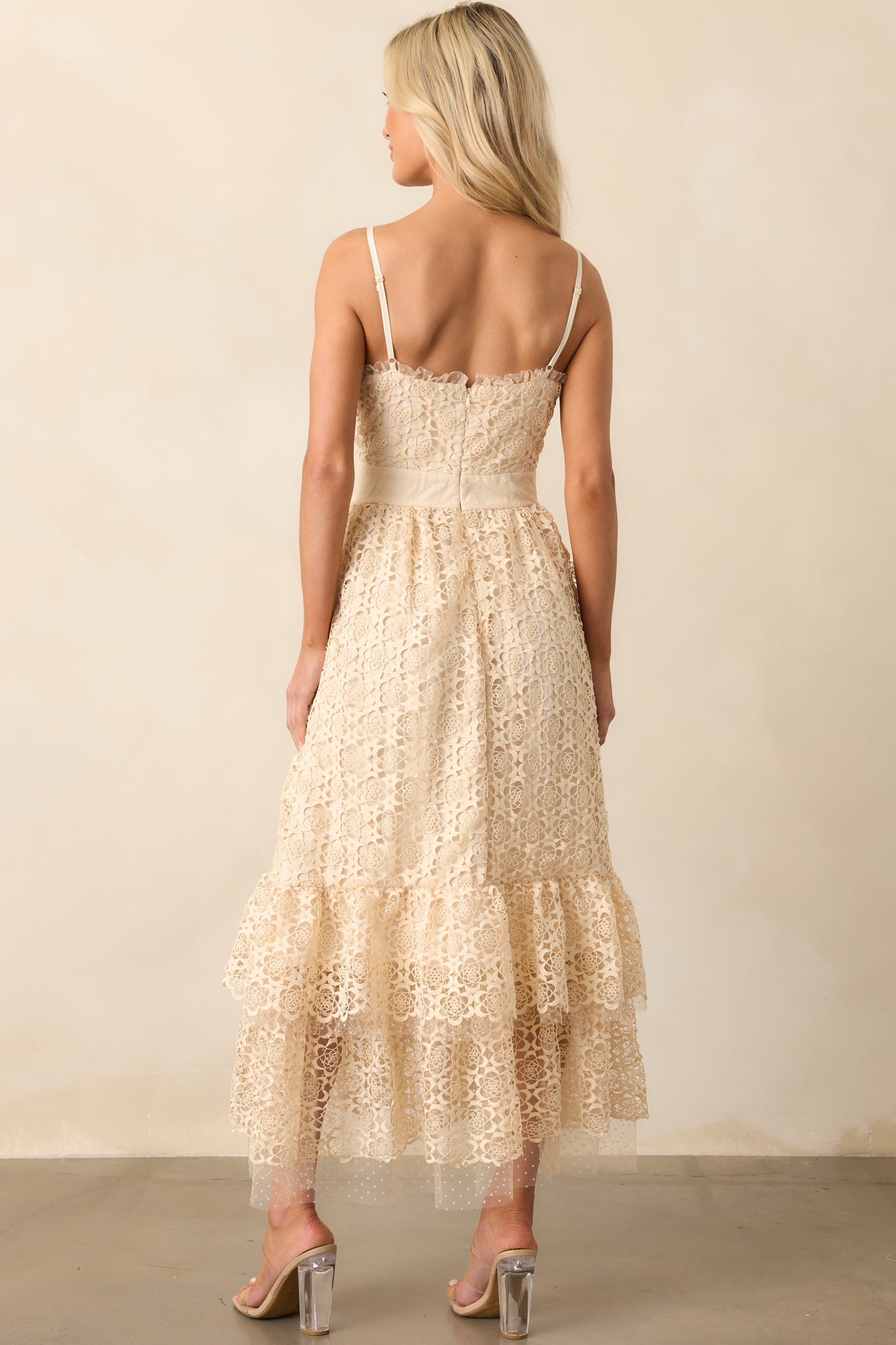 A back view of the natural midi dress featuring adjustable spaghetti straps and a discreet hidden zipper closure.