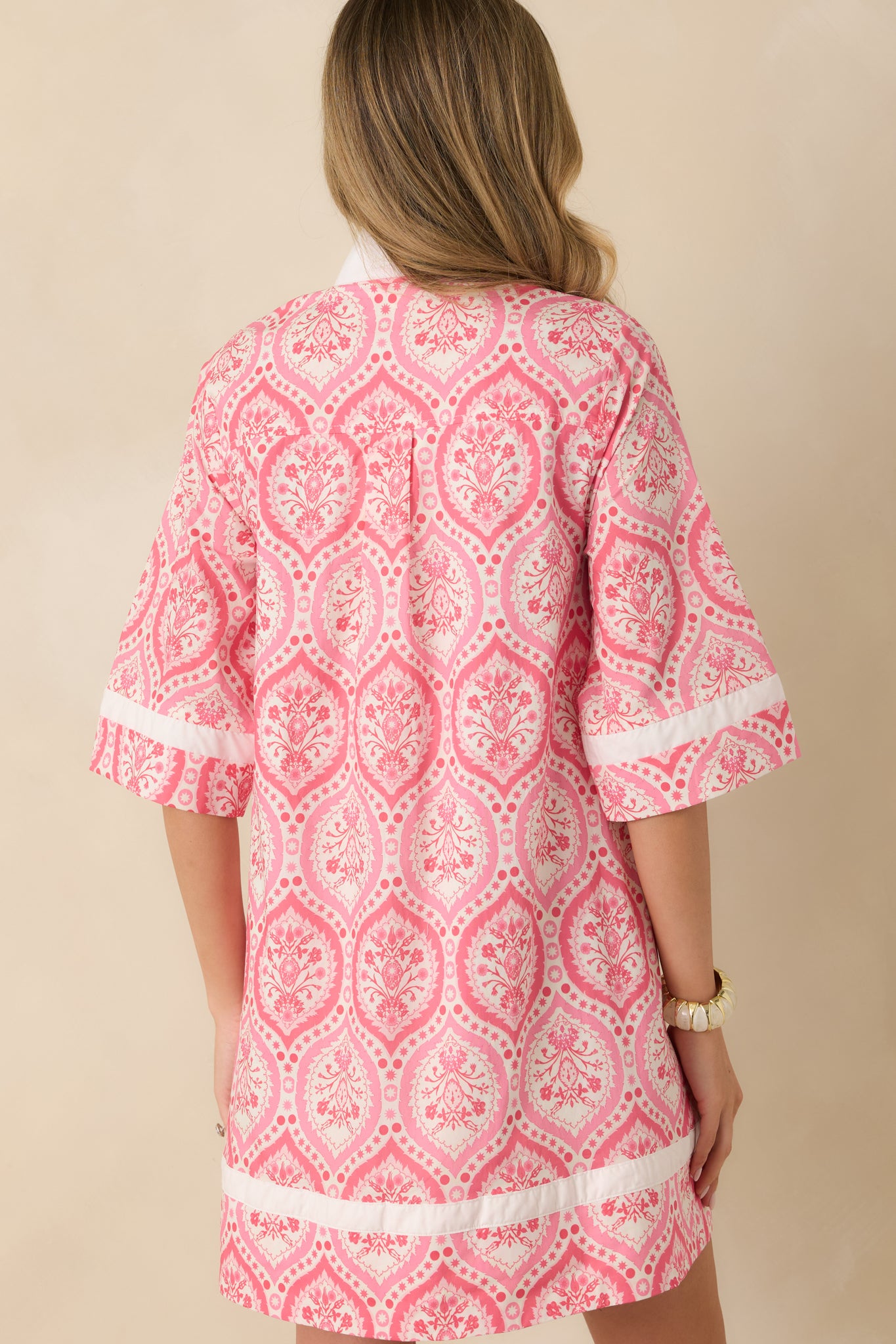 Back view of the pink floral mini dress showing the relaxed shift shape and straight hemline.