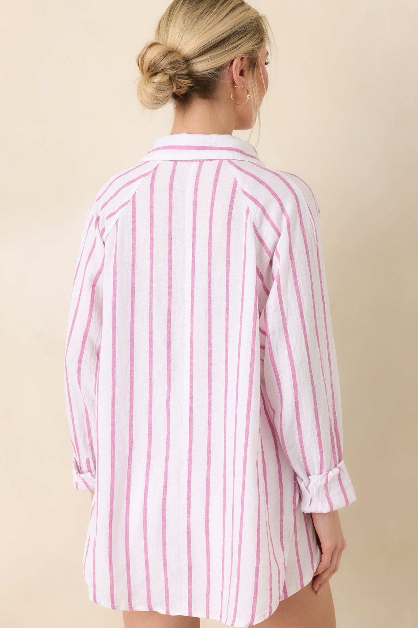 Back view of top displaying vertical pink stripes, relaxed fit, and smooth lightweight linen fabric.