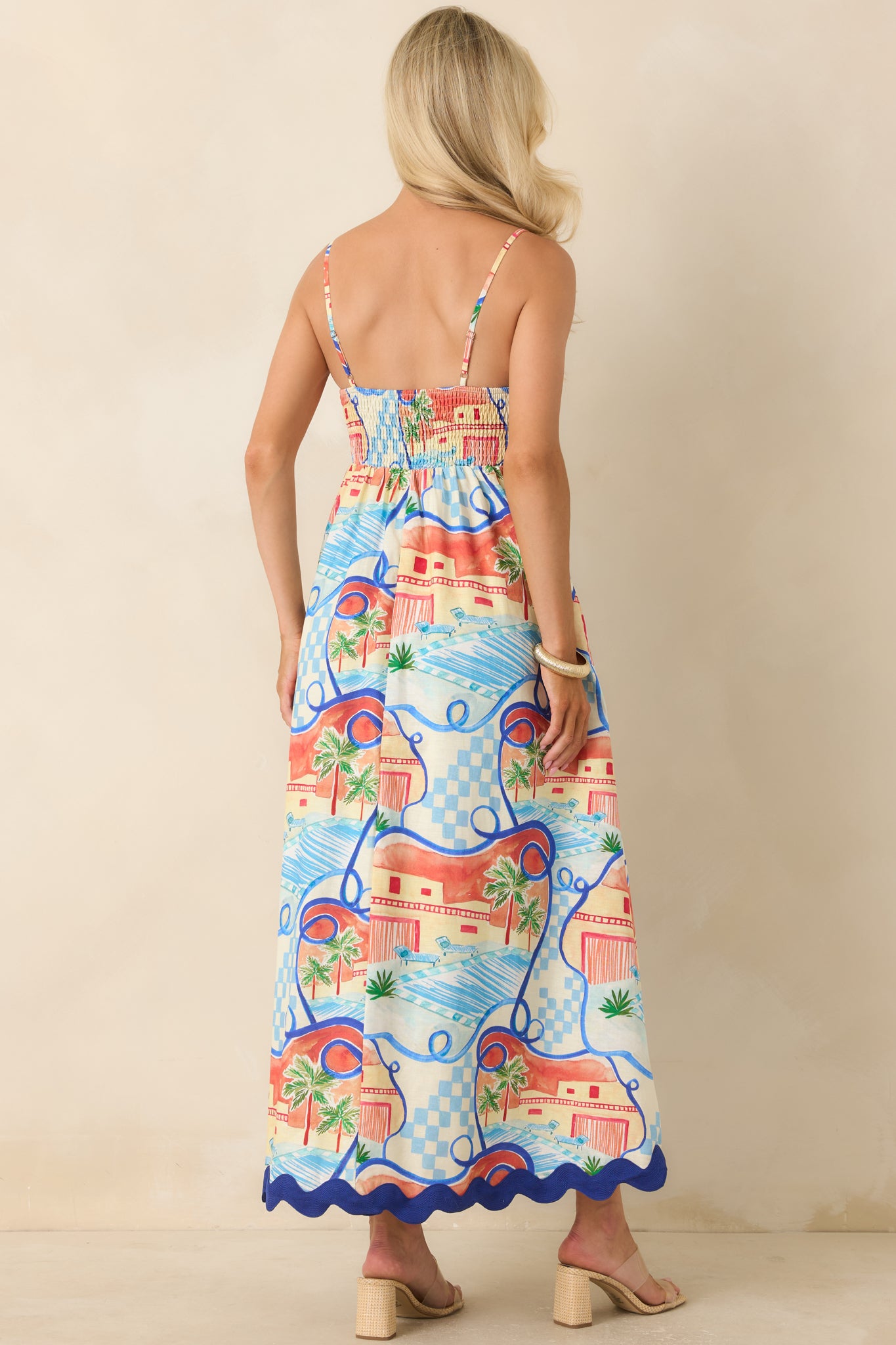 Back view of the printed maxi dress highlighting the comfortable smocked back panel and flowing full-length silhouette.
