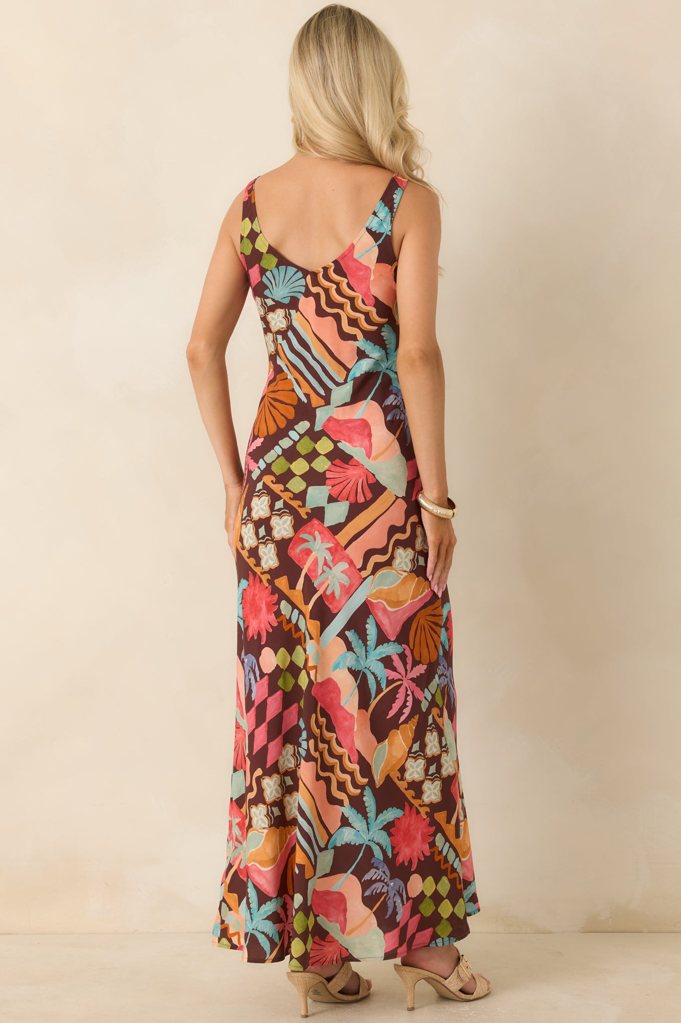 Back view of the printed midi dress highlighting the elegant low V-back design and flowing skirt silhouette.