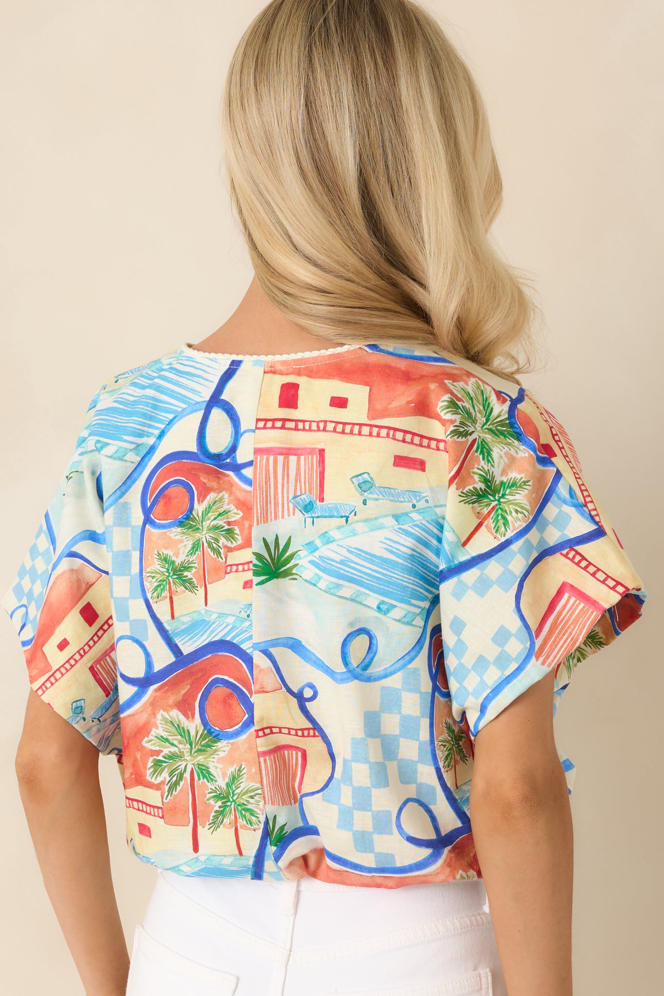 Back view of the printed top showcasing the relaxed silhouette, dolman sleeves, and effortless drape.