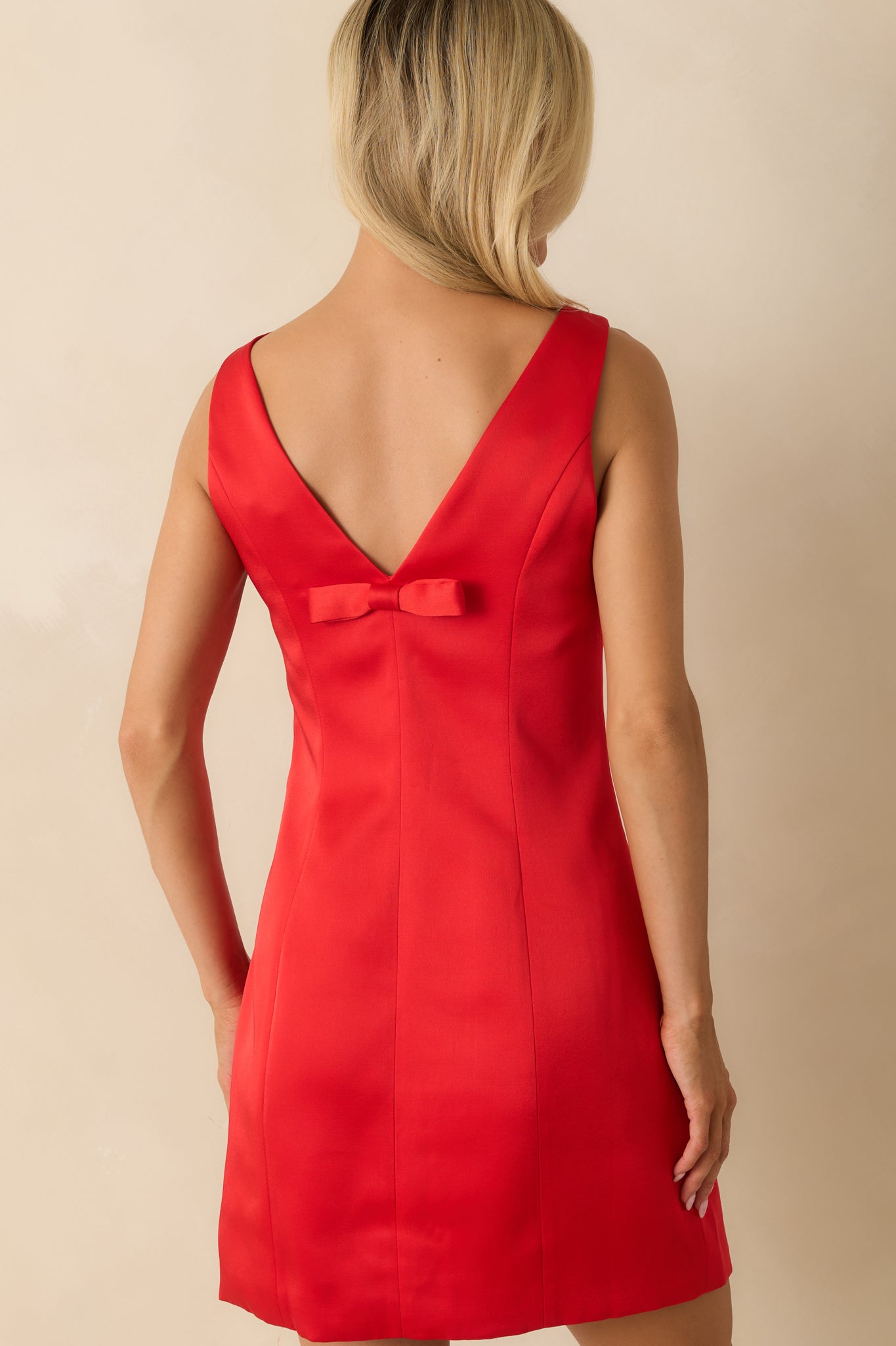 Back of the red mini dress highlighting the tailored fit and clean lines extending from the shoulders to hem.