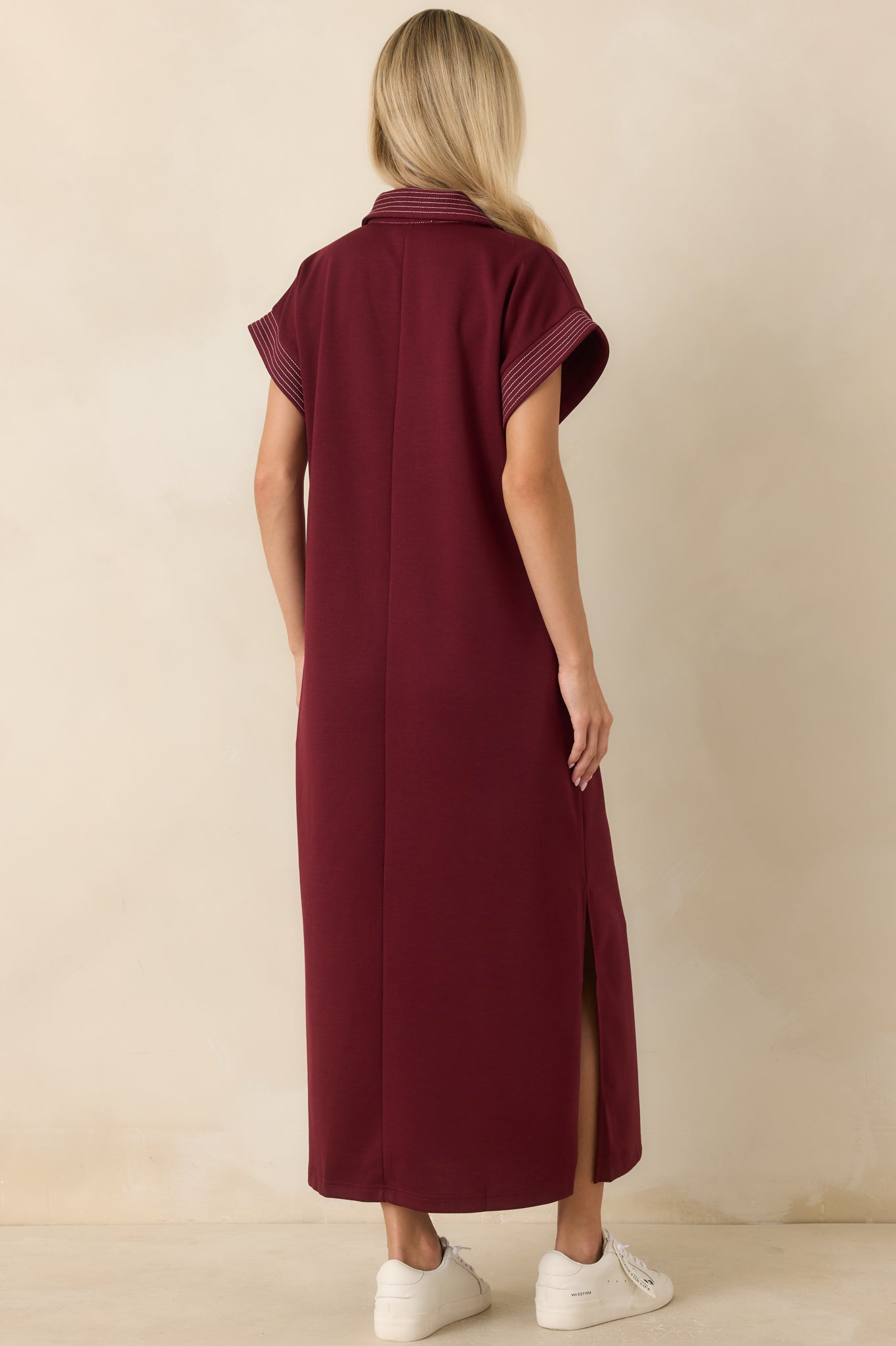 Back view of the relaxed fit dress featuring a simple silhouette and side slit details.