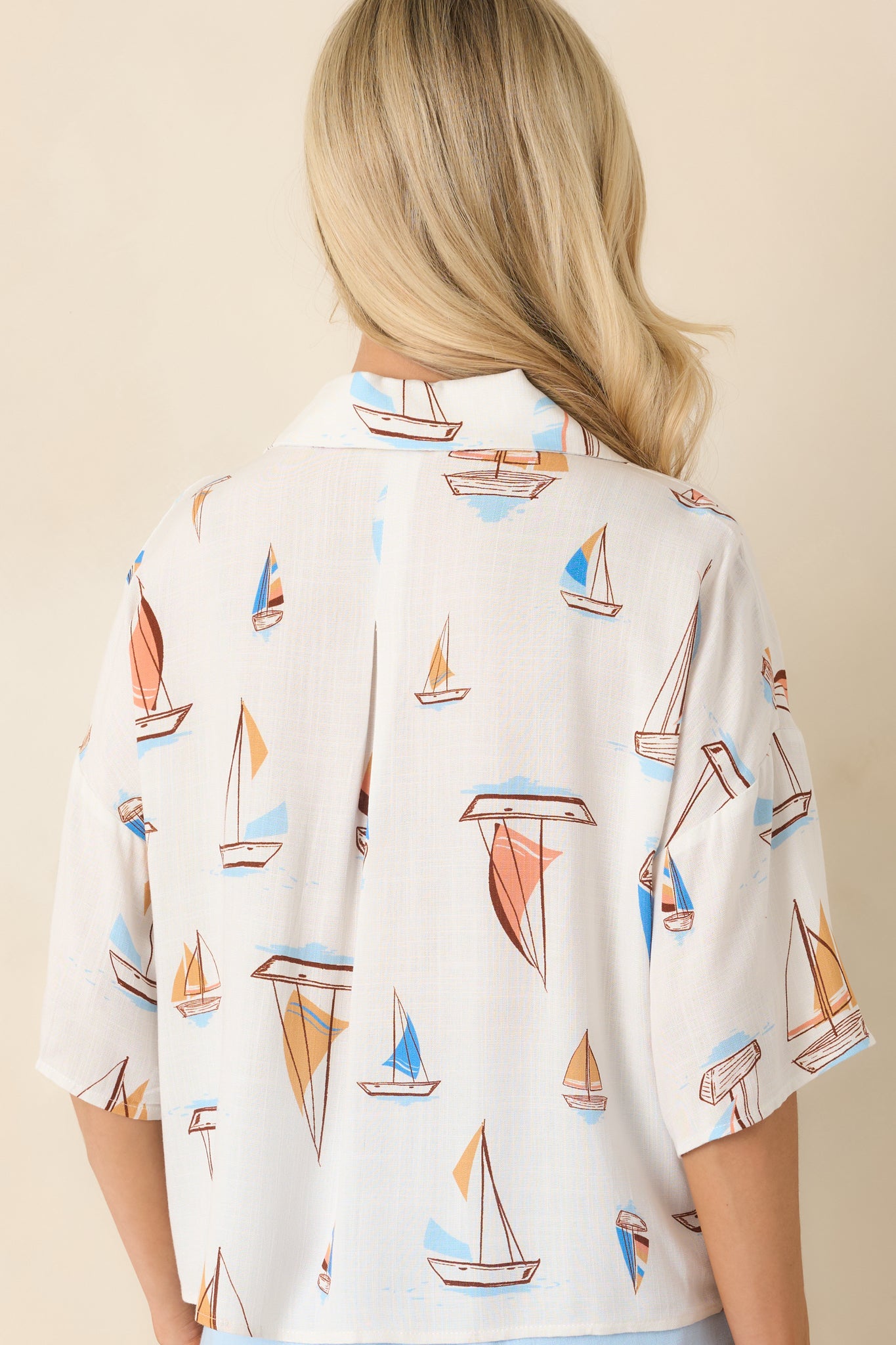 Back view of the sailboat print top showcasing the relaxed silhouette and lightweight woven fabric.