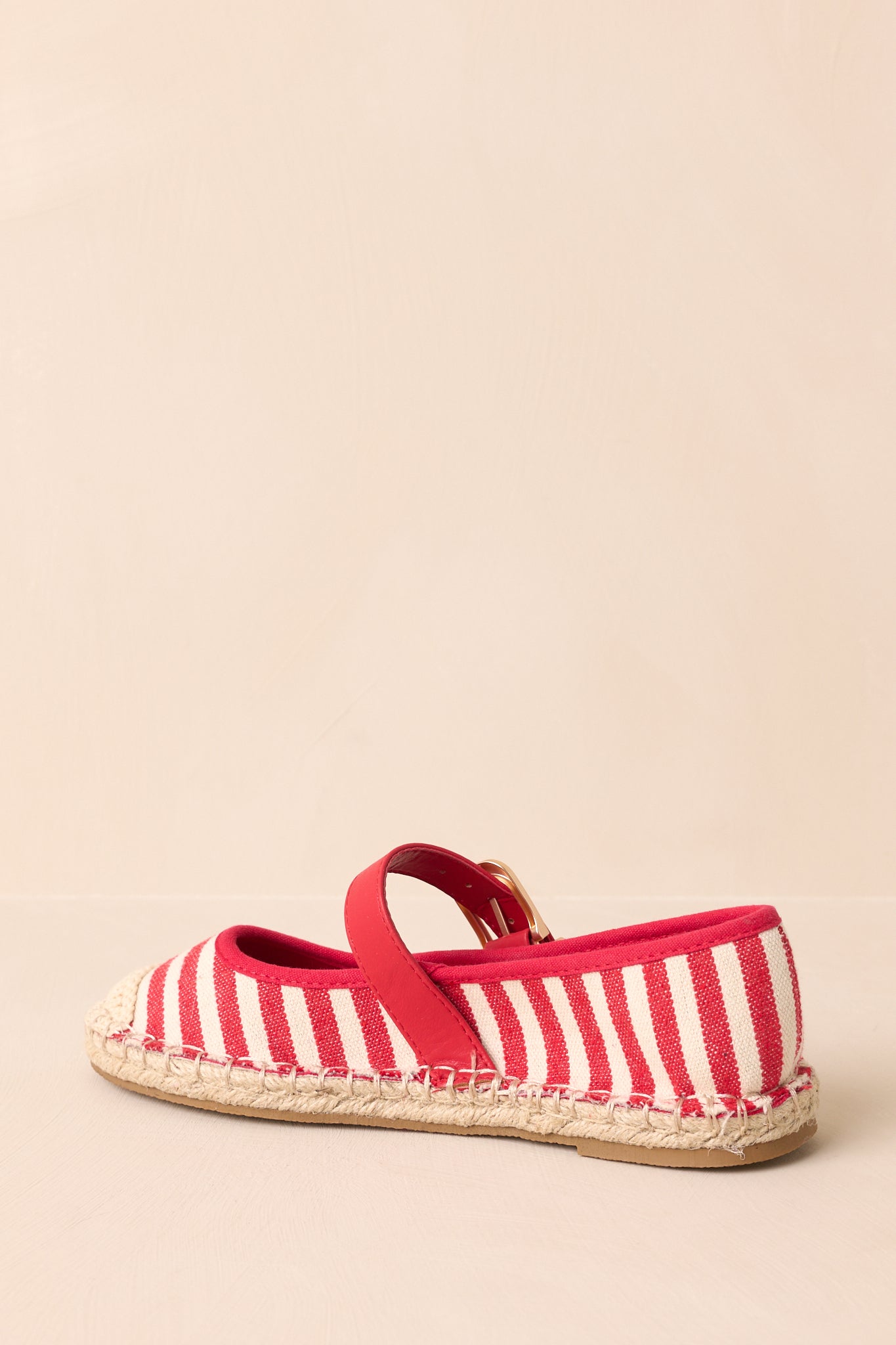 Back view showing the heel area, braided jute sole, and stripe pattern on the canvas flats.