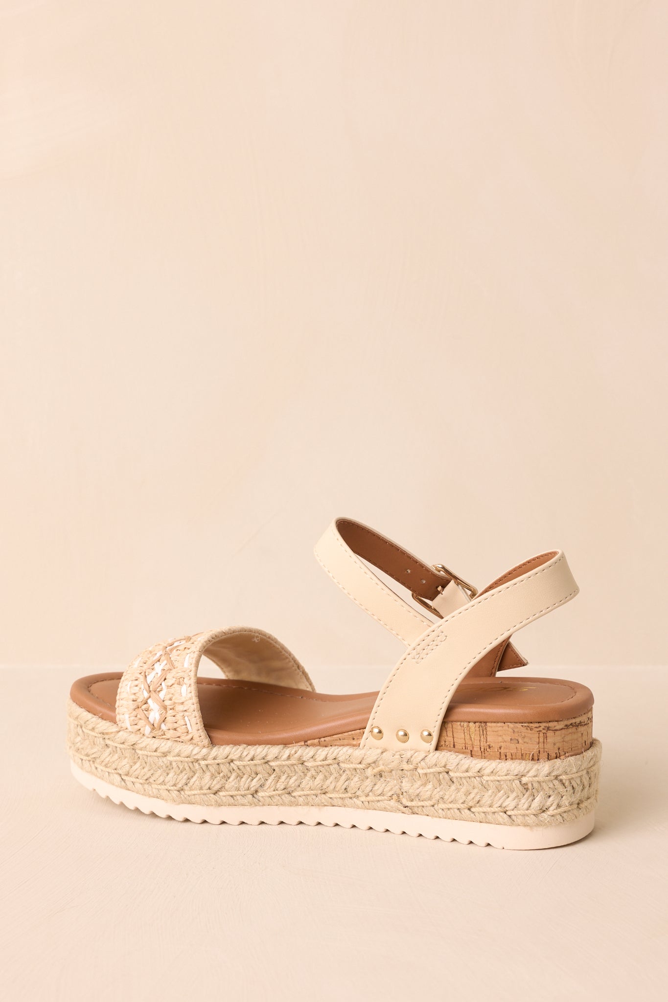 Back view showing the heel strap, cork wedge insert, and jute-wrapped platform sole.