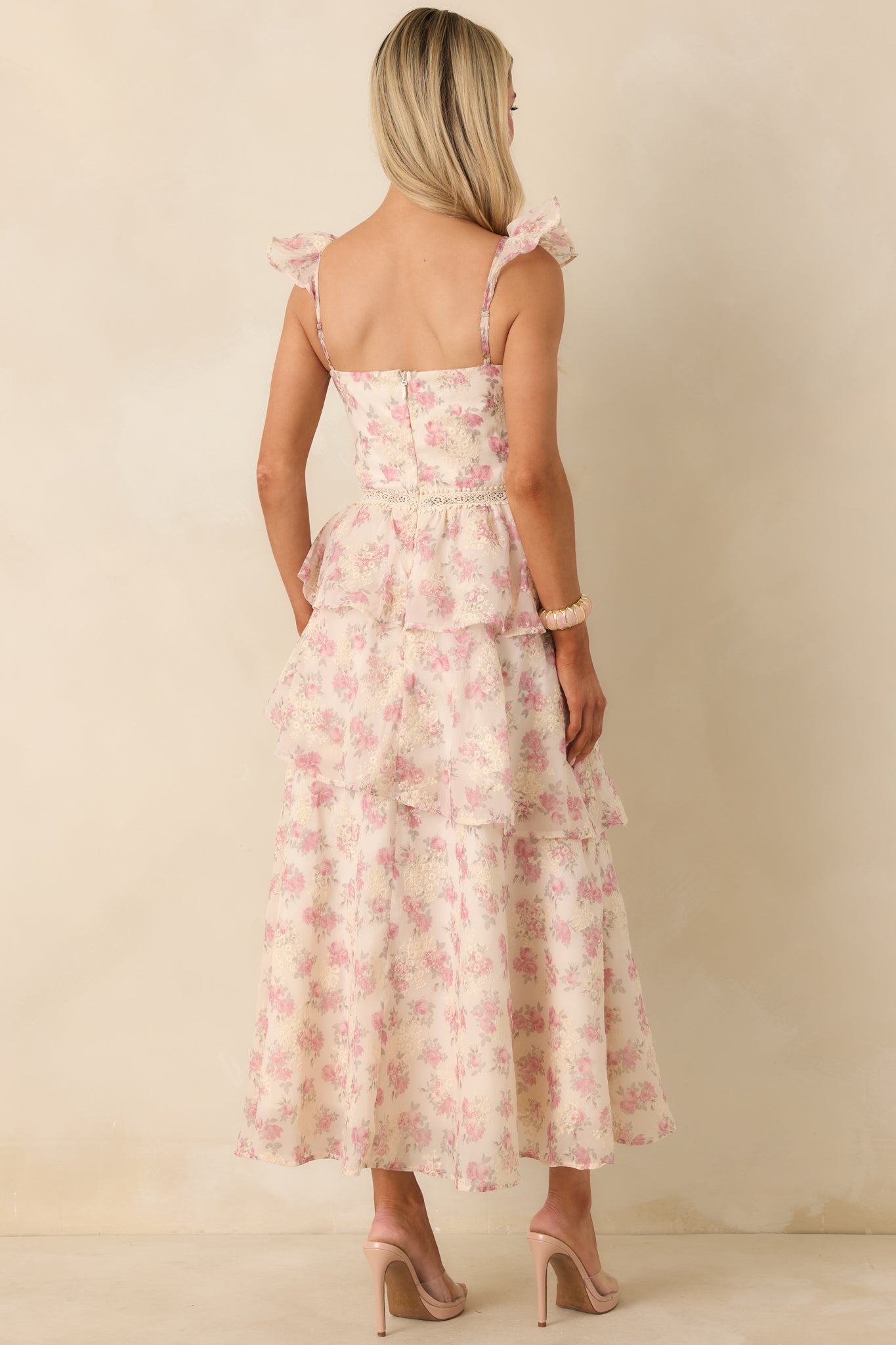 Back view of the beige floral dress showing the discreet zipper closure and adjustable straps.