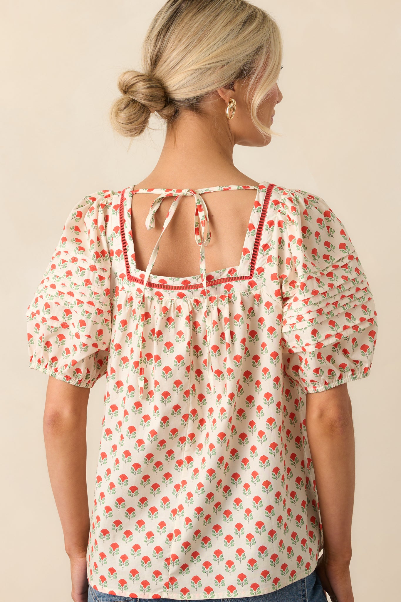 A back view of the cotton top showing the self-tie closure and elastic detail at the back, along with the allover red floral print.