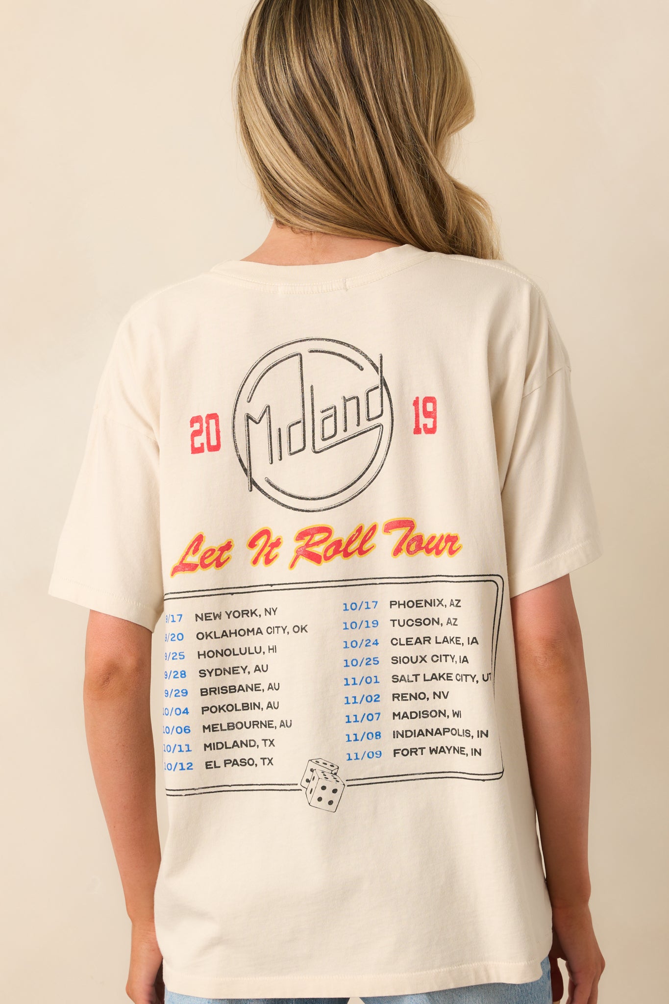 A back view of the tee showing the tour details graphic centered on the back with a classic crew neckline.