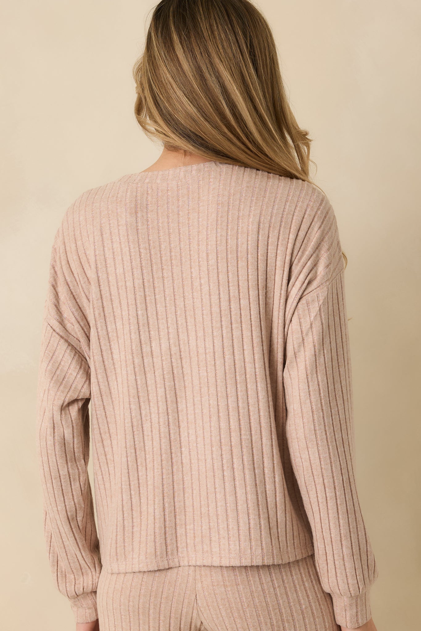 Back view of the taupe top showing relaxed silhouette and smooth ribbed finish.