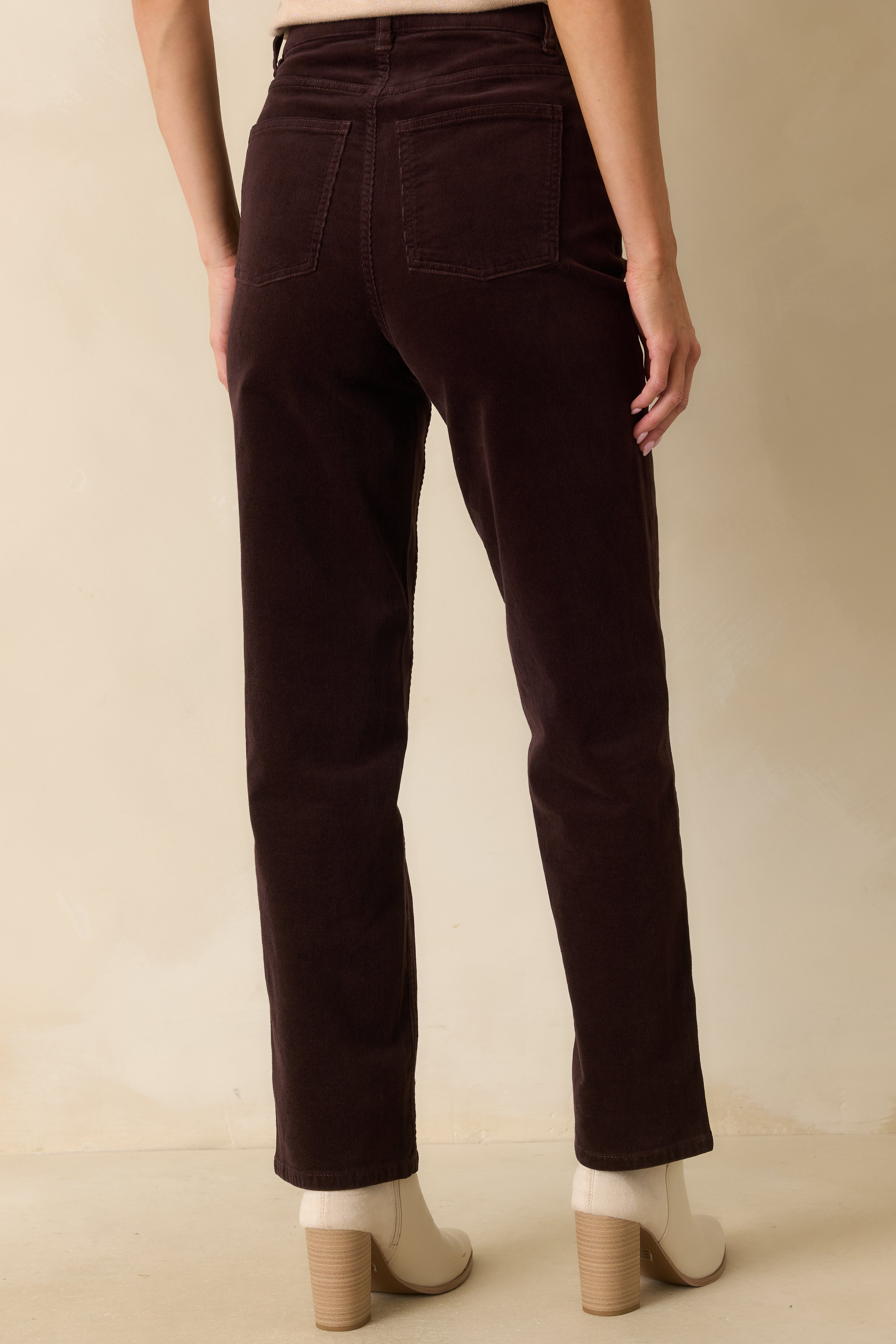 Rear view of the truffle brown corduroy jeans showing functional back pockets and straight-leg fit.