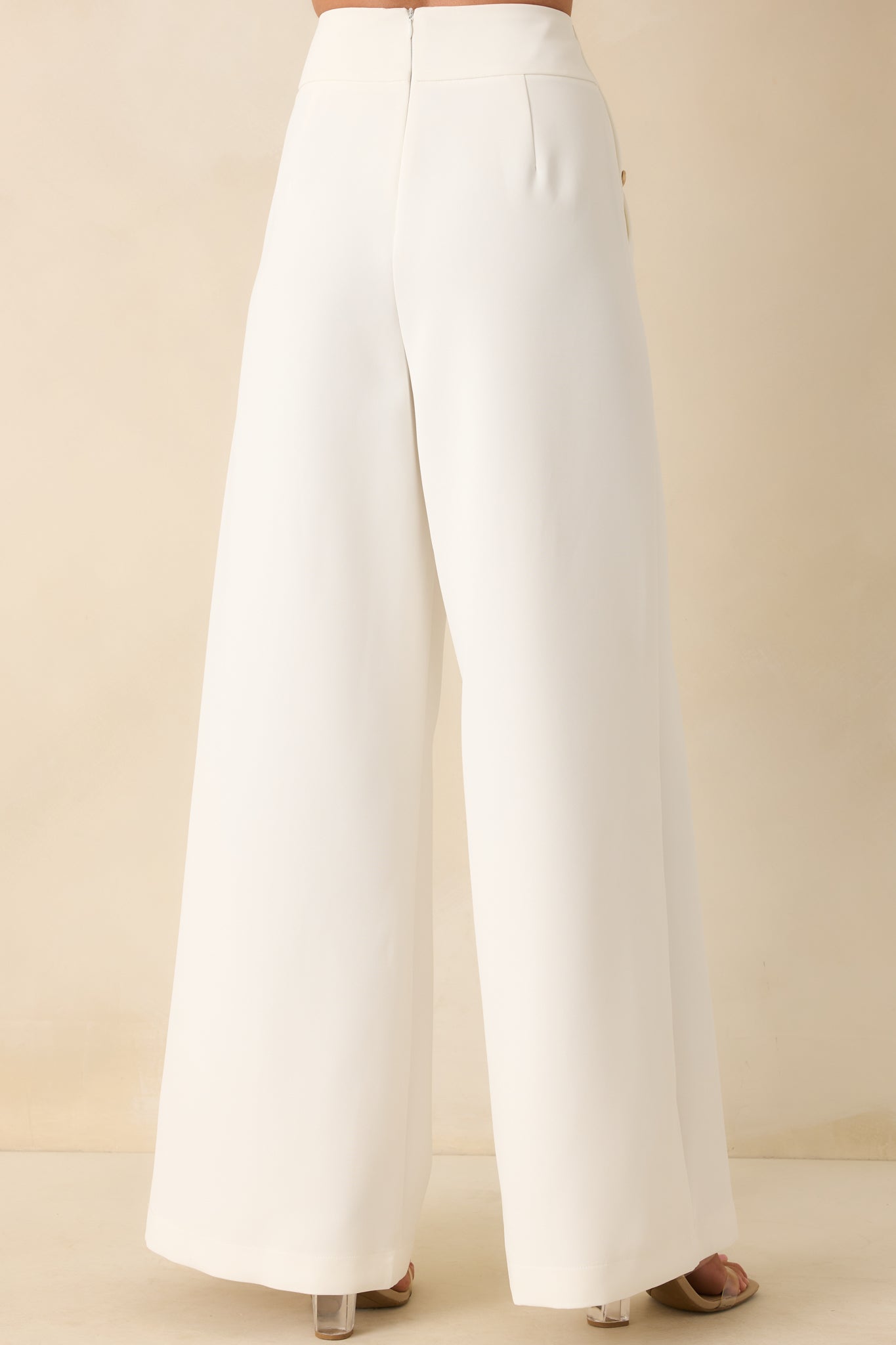 Back view of the white pants showing the discrete zipper and wide leg fit from behind.