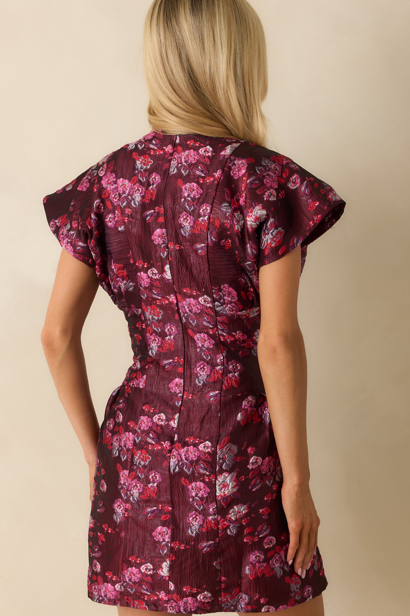 Back view of the wine purple metallic jacquard mini dress with concealed back zipper and fitted silhouette.