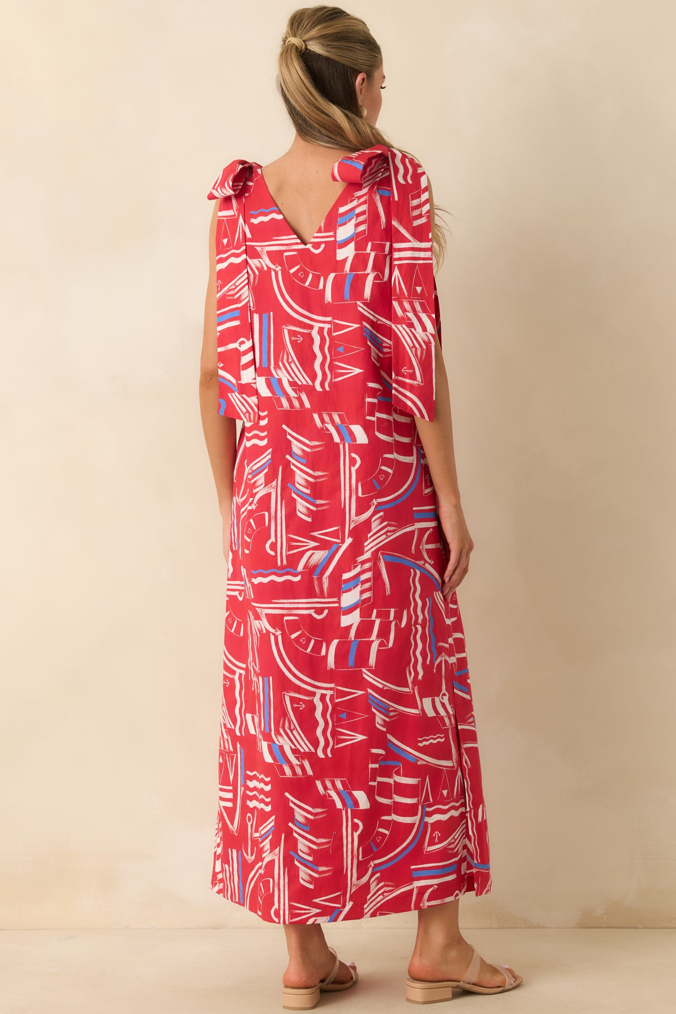 Back view of the lightweight cotton maxi dress featuring wide shoulder straps, oversized bows, and a relaxed flowy silhouette.