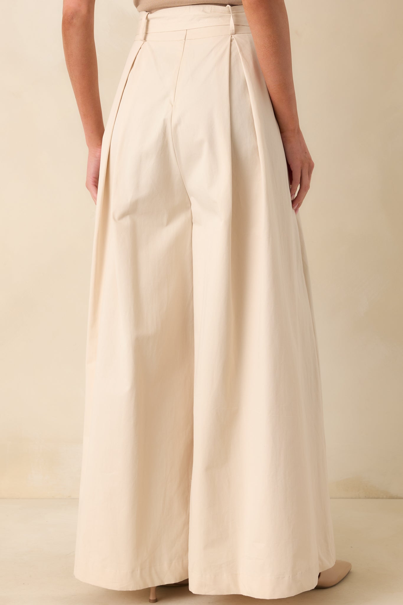 A view from behind showing the high waisted fit, smooth back waistband, and wide full-length legs.