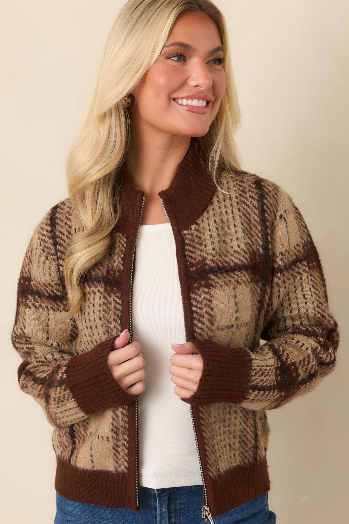 Plaid knit cardigan with a ribbed stand collar and full-length front zipper.