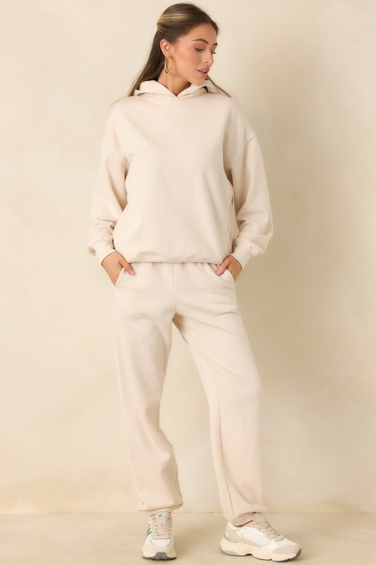 Cotton-blend joggers in a soft beige shade with roomy legs and functional side pockets.