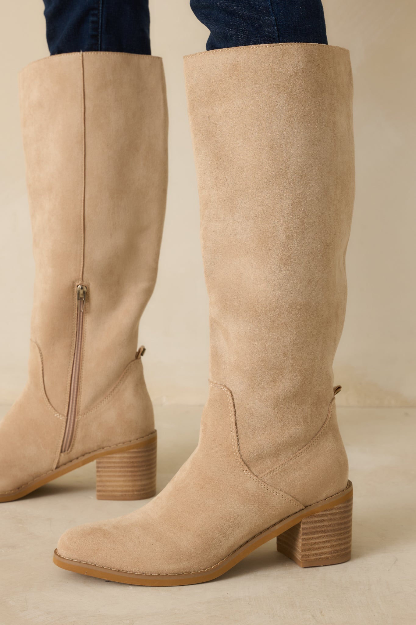 Beige faux suede boots highlighting the almond toe and smooth soft finish.