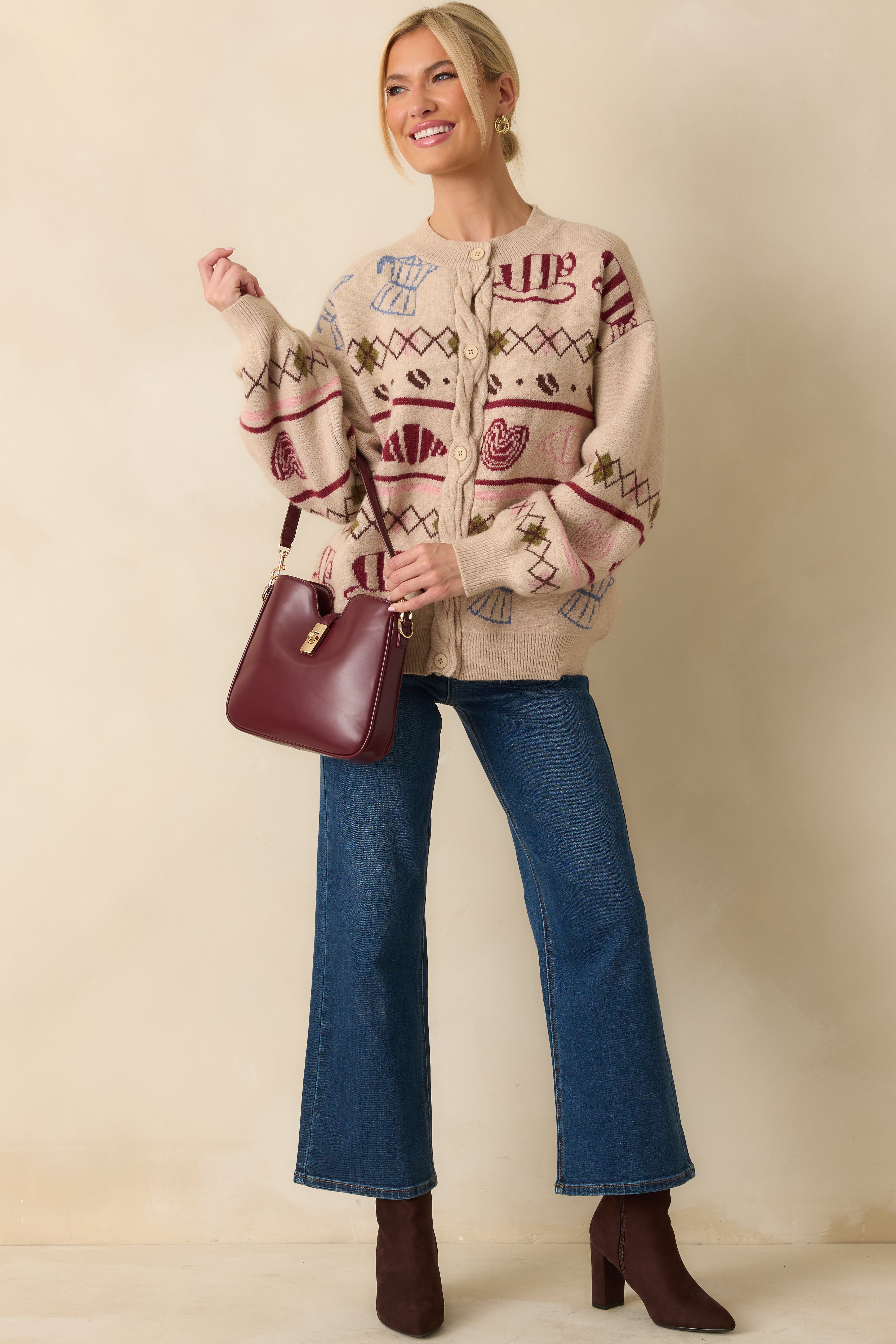 Beige knit cardigan featuring a playful coffee and pastry motif with a relaxed, cozy fit.