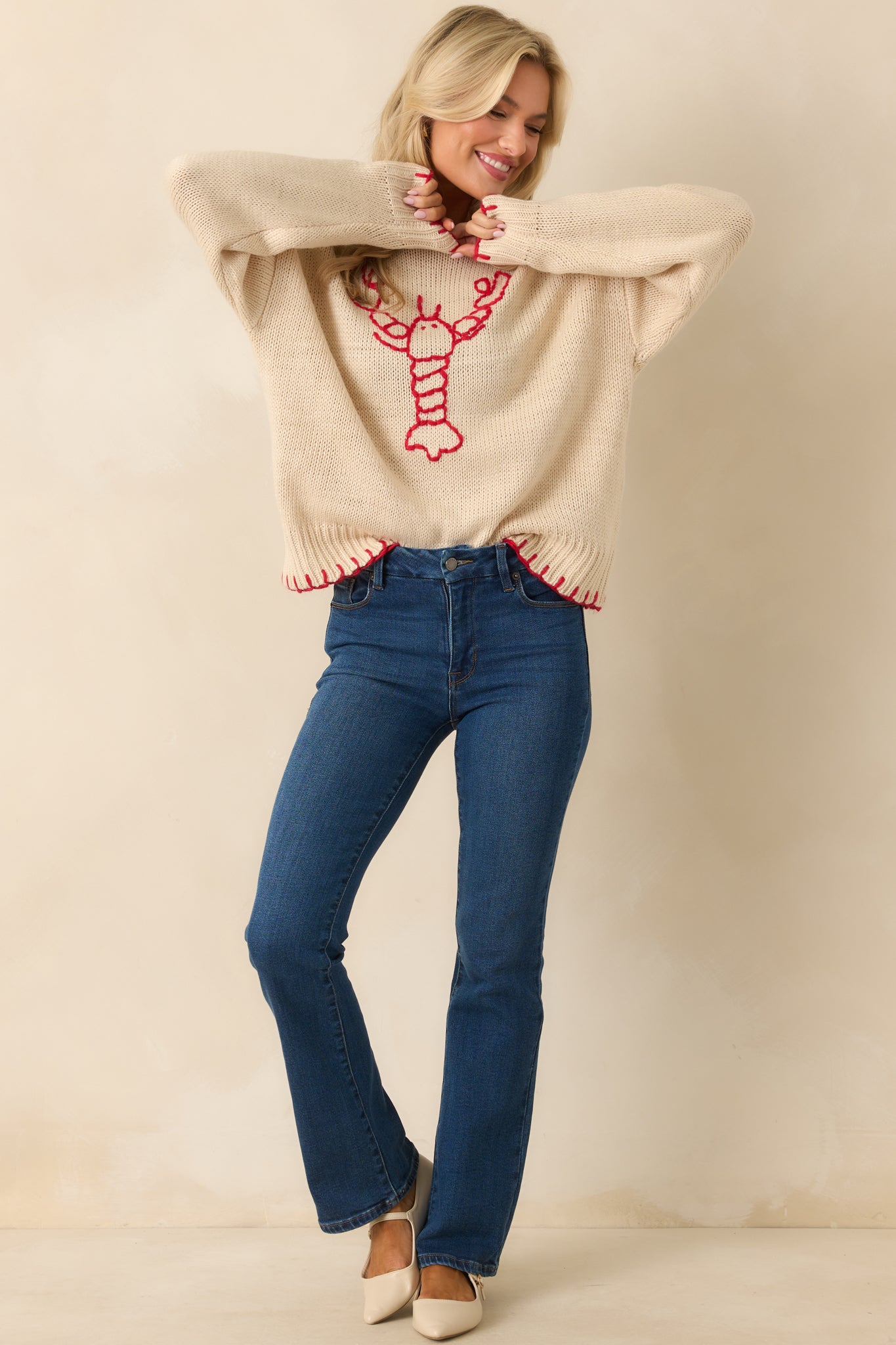 Long sleeve knit sweater in beige featuring a playful lobster design and crew neckline.