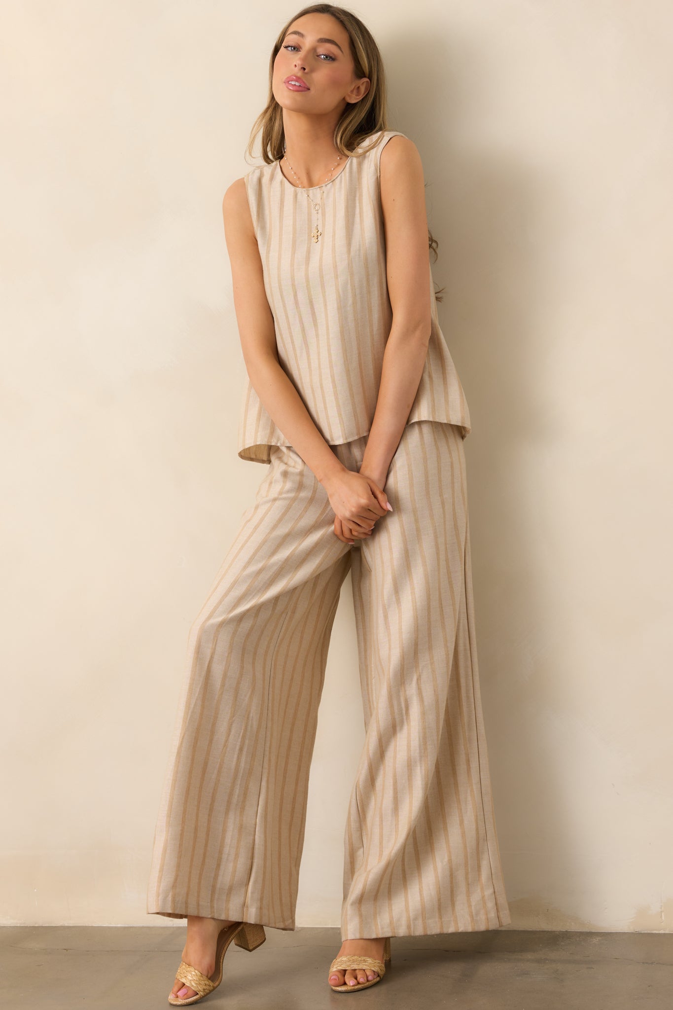 Beige pants with a stylish stripe print, a tailored wide-leg design, and a clean, polished silhouette.