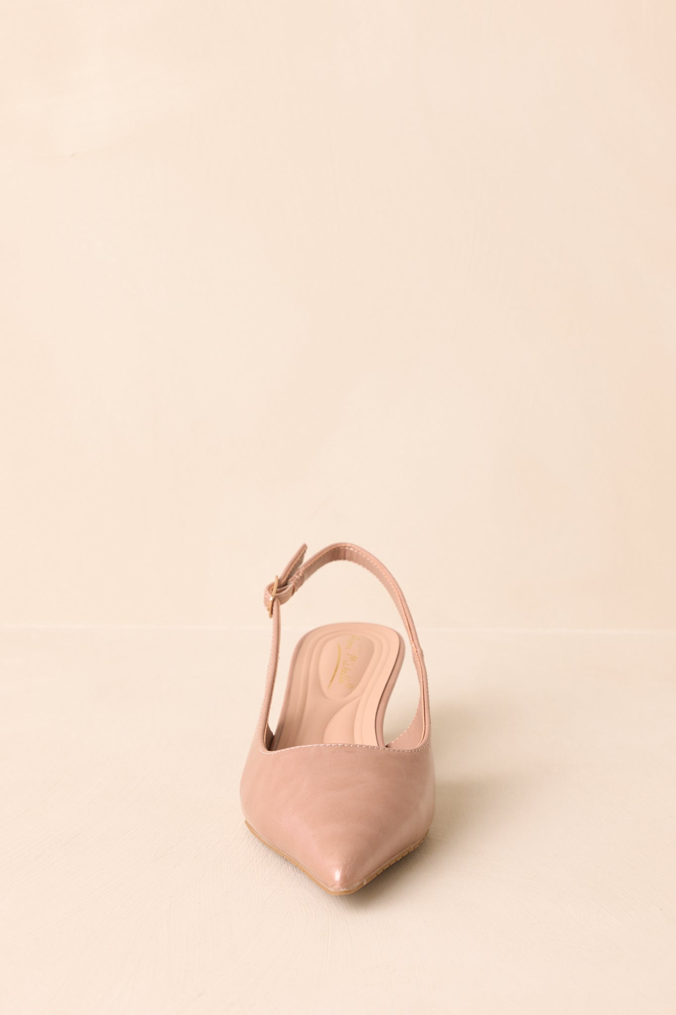 Beige patent slingback heels displayed at a front angle with pointed toe in view.