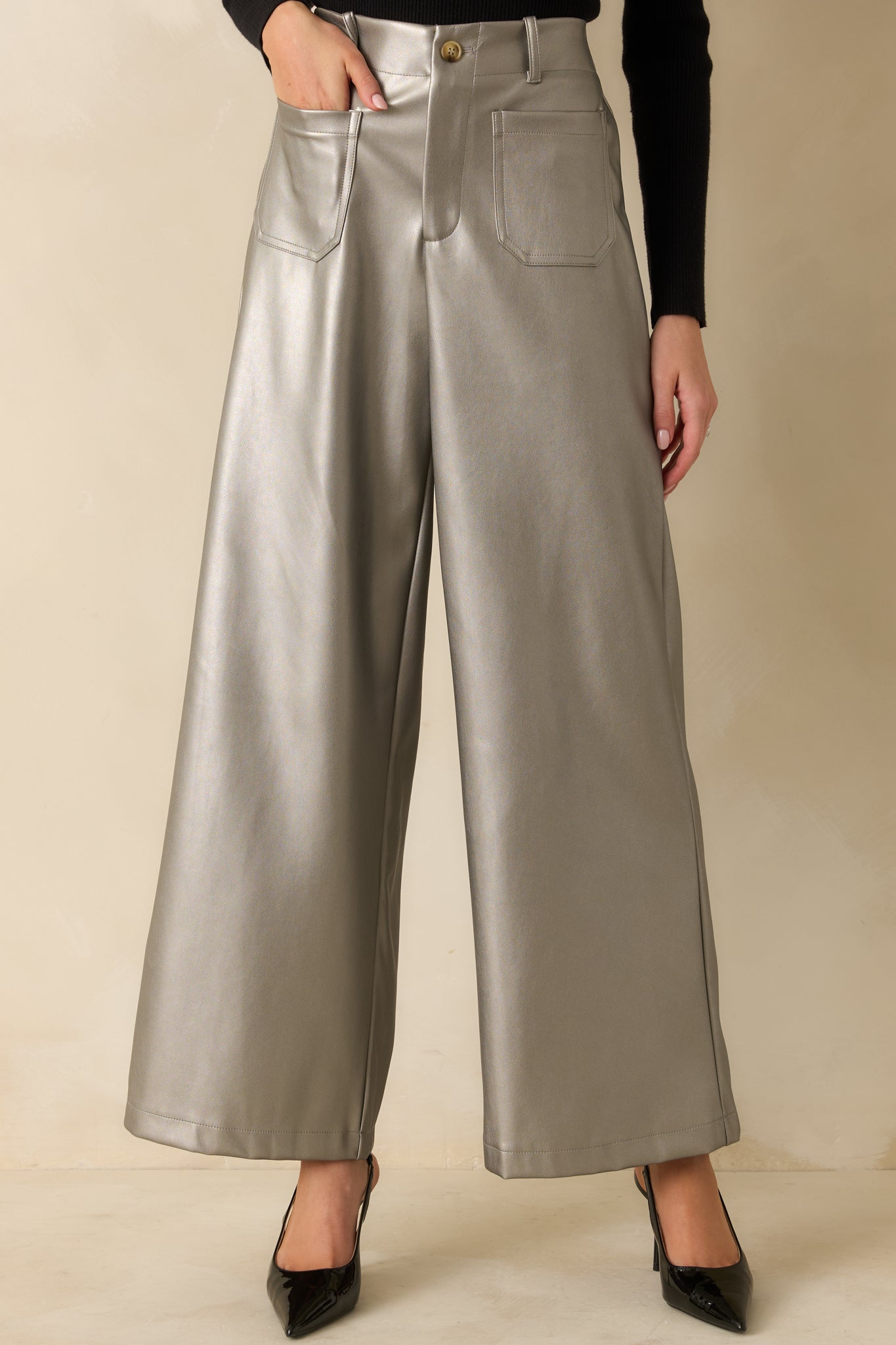 Belt loops and button zip fly closure highlighted on the shimmering grey metallic fabric.
