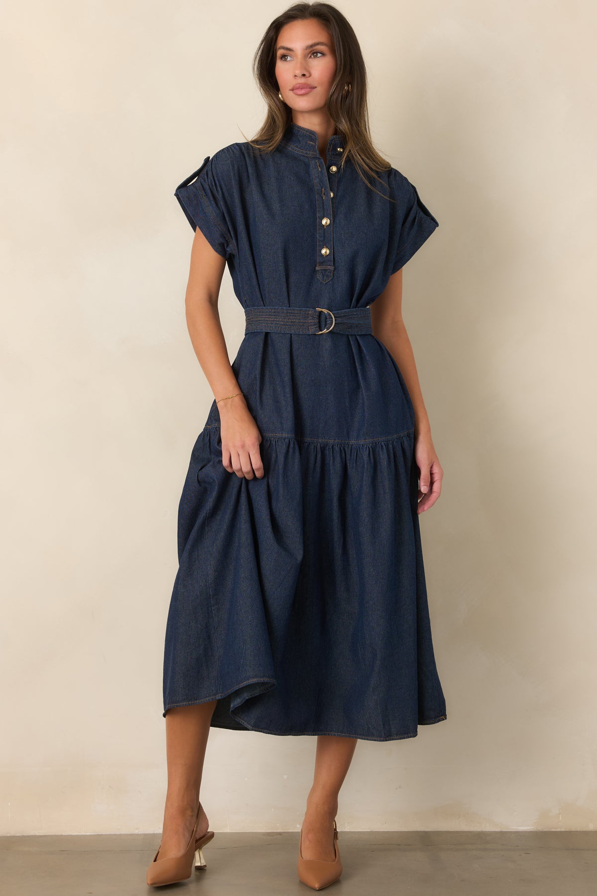 Belted dress showcasing the gold-tone buttons and tiered silhouette.