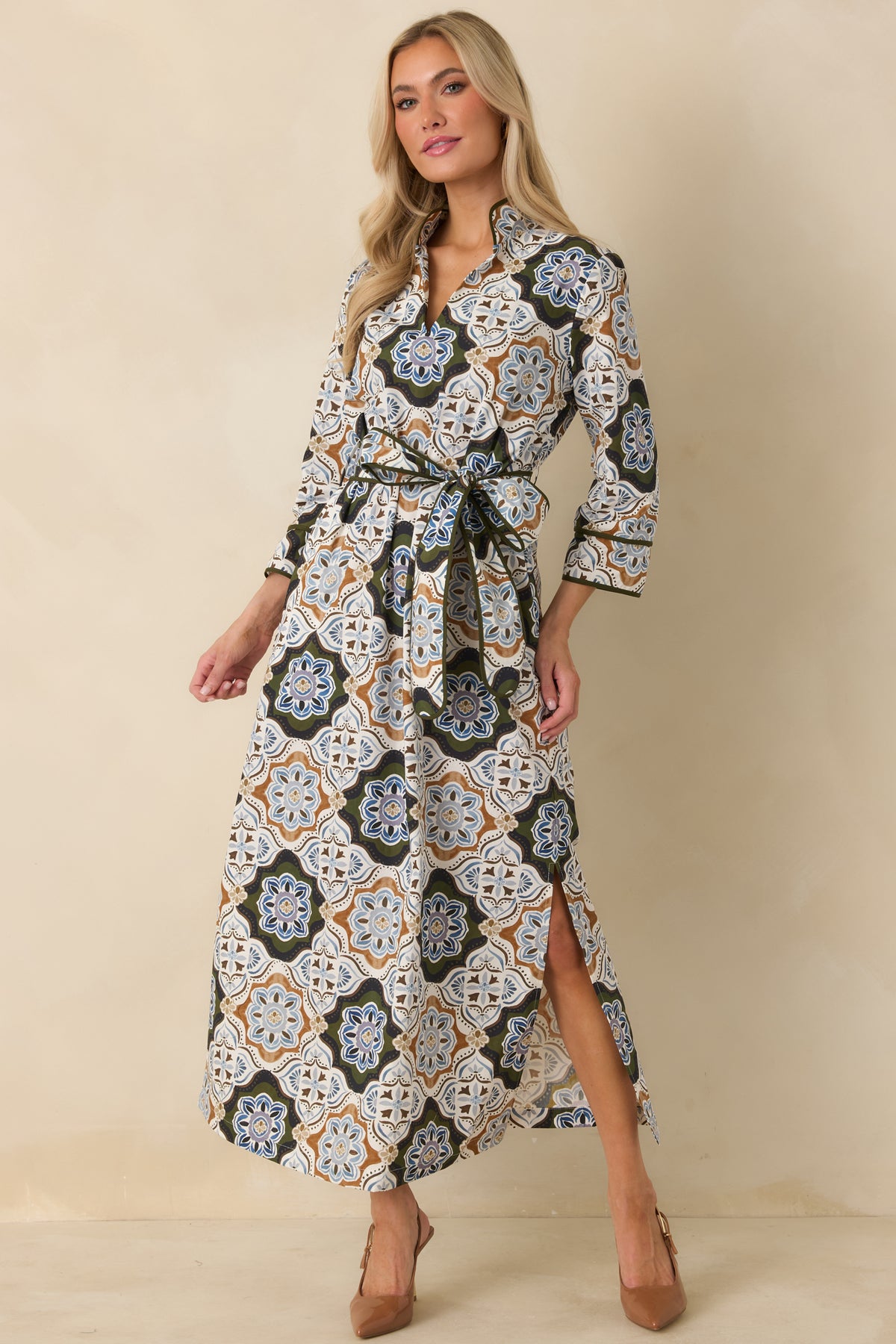 Belted medallion print maxi dress with three-quarter sleeves, contrast olive piping, split neckline, and a flowing side-slit skirt.