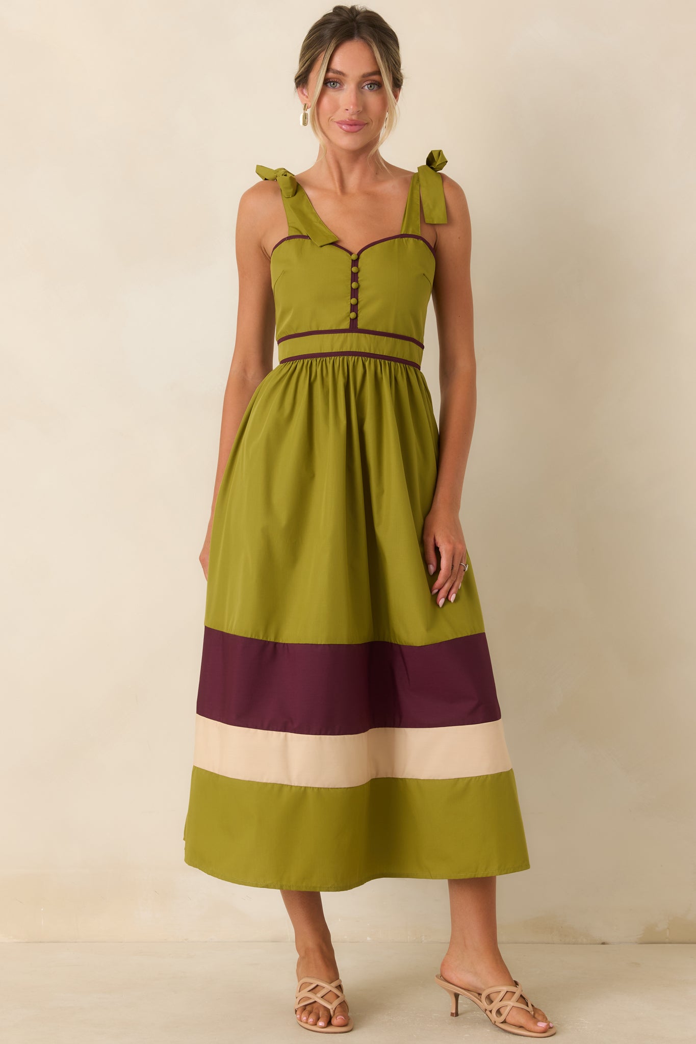 Color-blocked midi dress with berry and ivory accents, decorative buttons, and a flattering fitted bodice