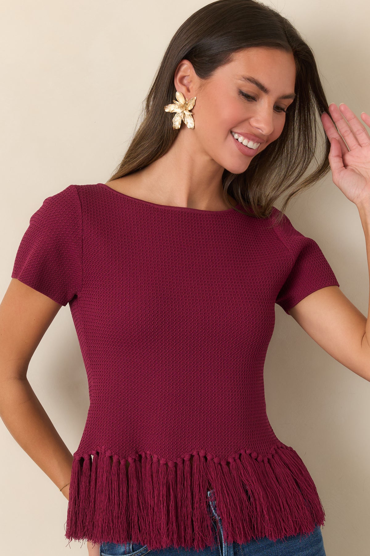 Berry textured knit top highlighting the boat neckline and short sleeves.