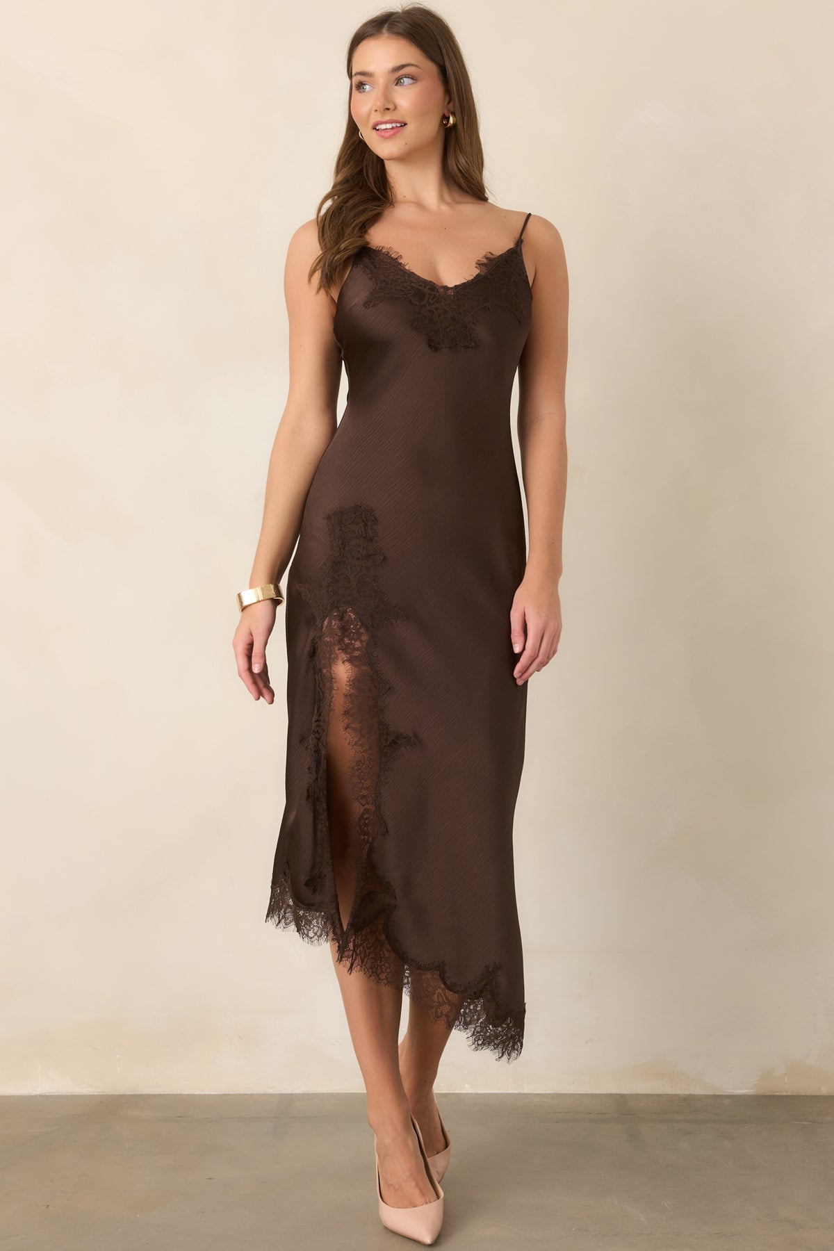 Bias-cut satin midi dress with adjustable spaghetti straps, a softly draped silhouette, and an asymmetrical hem finished with delicate eyelash lace.