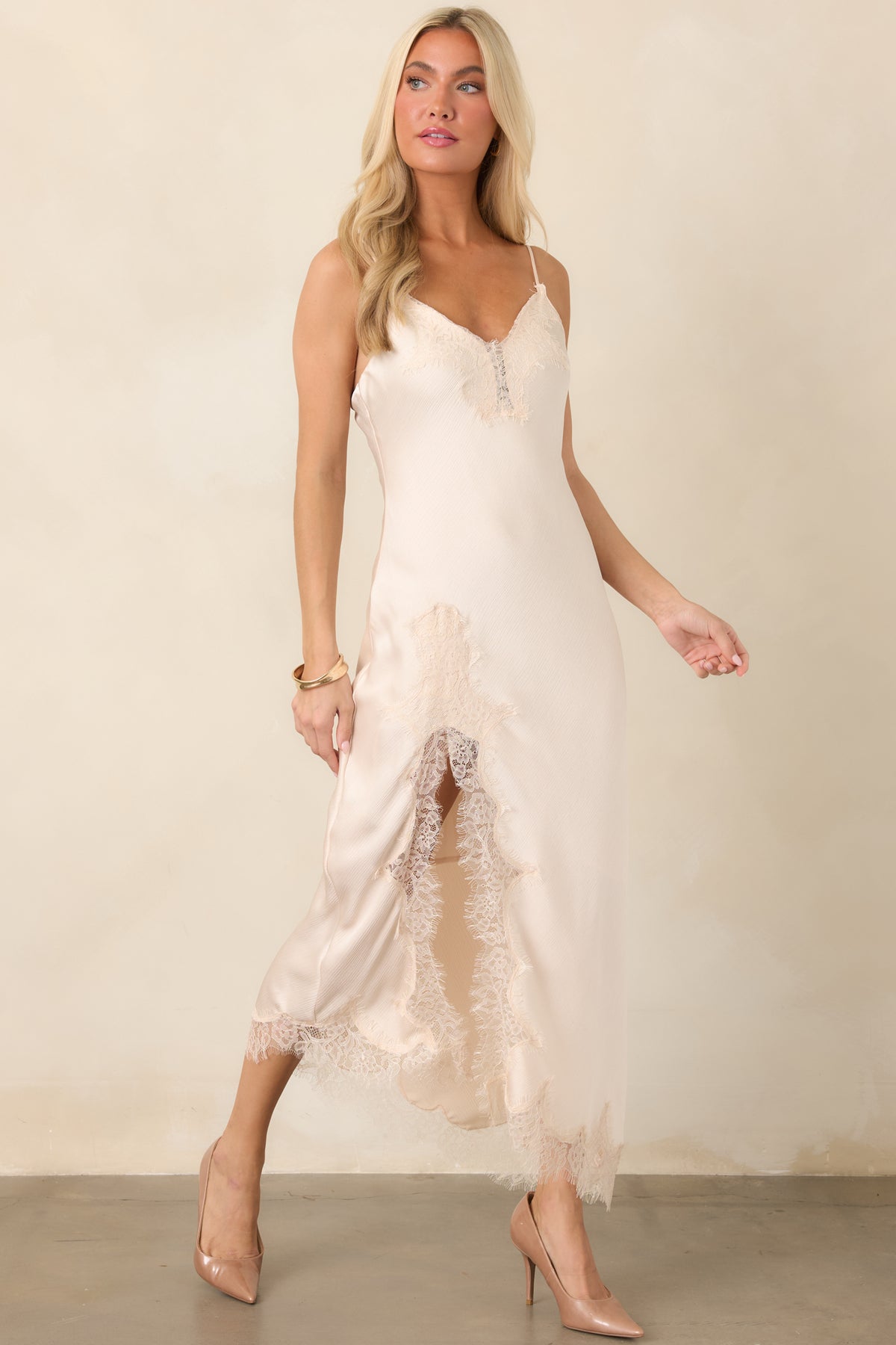 Elegant bias-cut midi dress featuring delicate spaghetti straps, a body-skimming silhouette, and an asymmetrical lace-accented hem.