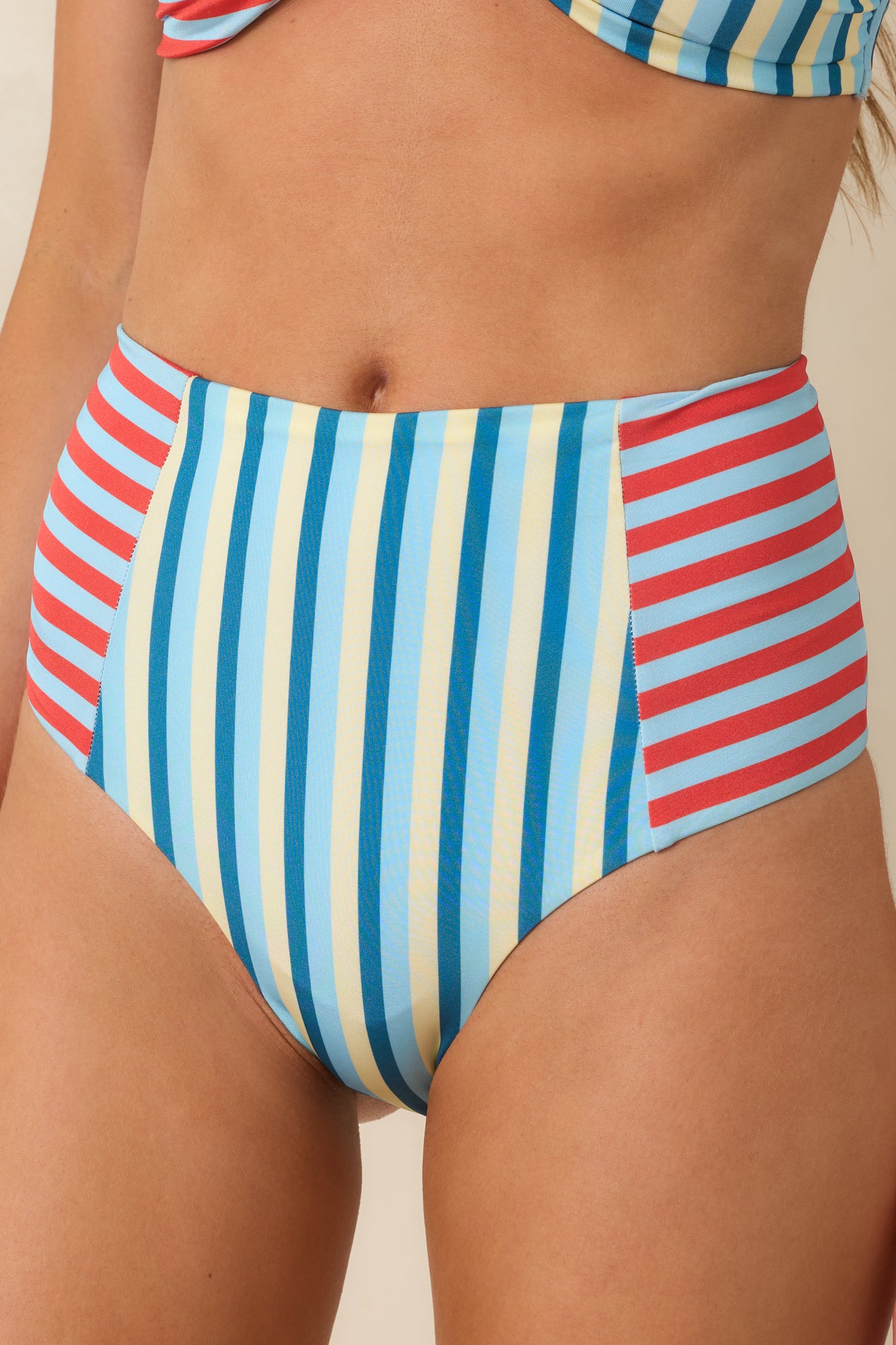 Close-up of the bikini bottoms featuring the contrast stripe paneling, stretchy texture, and colorful swim fabric.