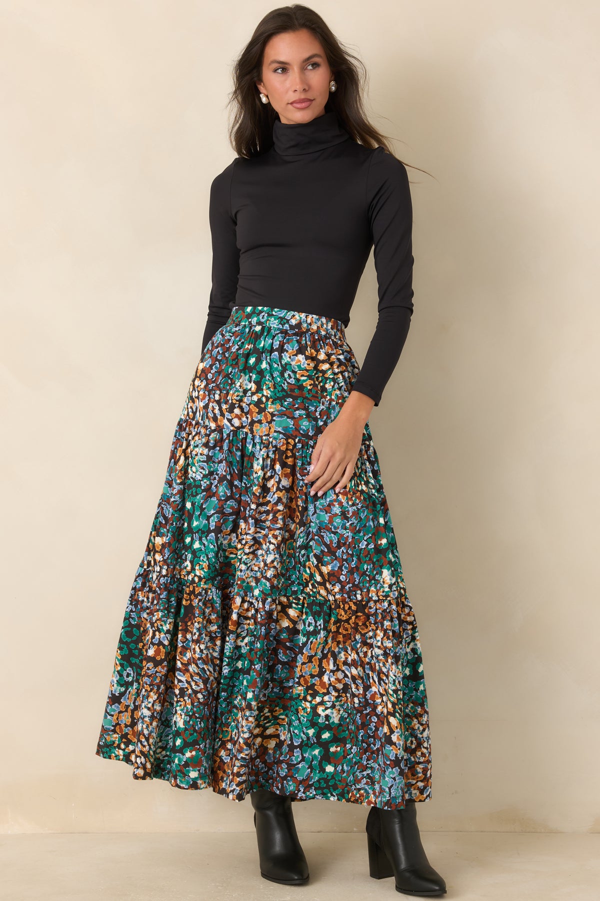 Black tiered skirt featuring a flowing silhouette and colorful abstract animal print.