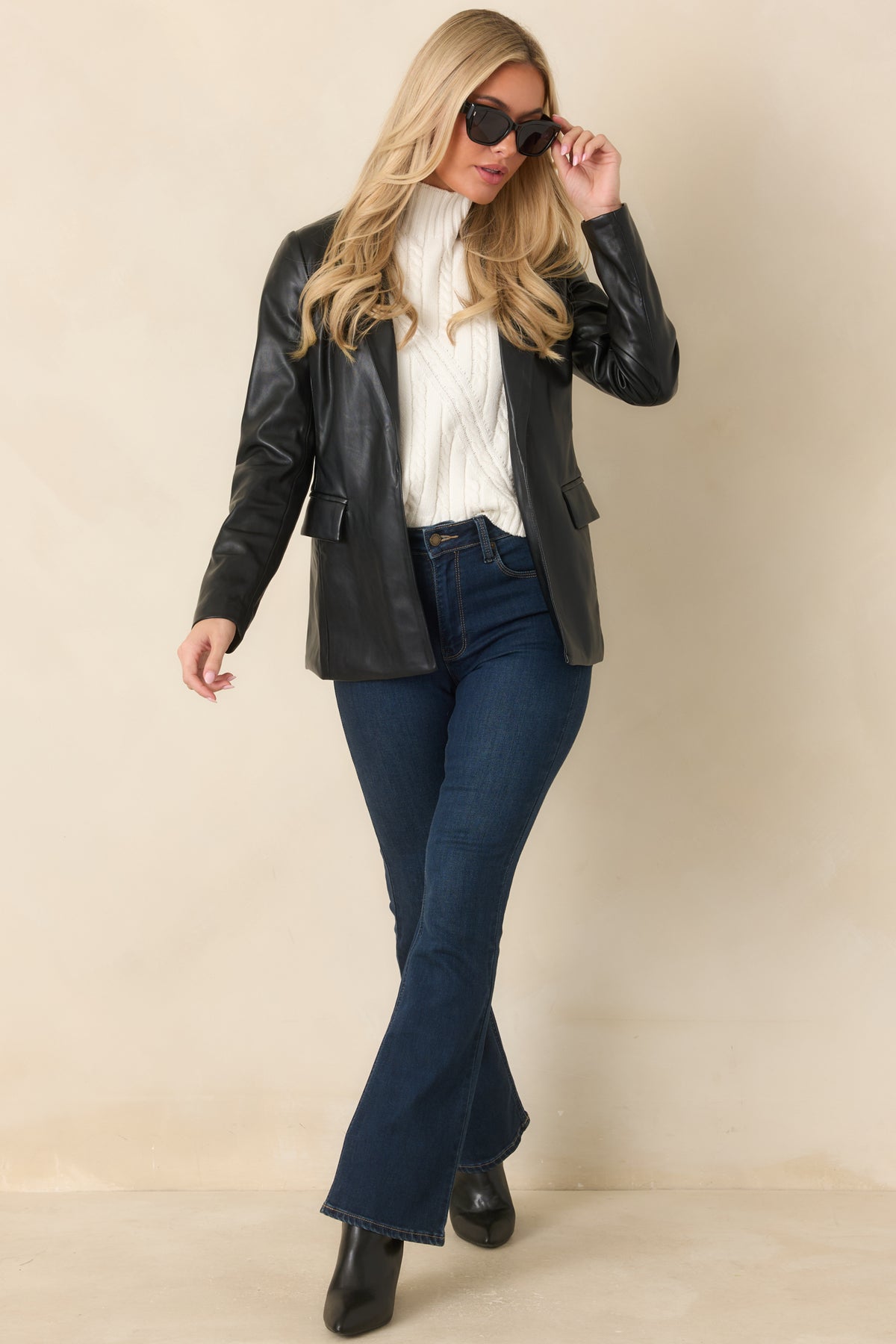 Hip-length black faux leather blazer featuring long sleeves and structured notched lapels.