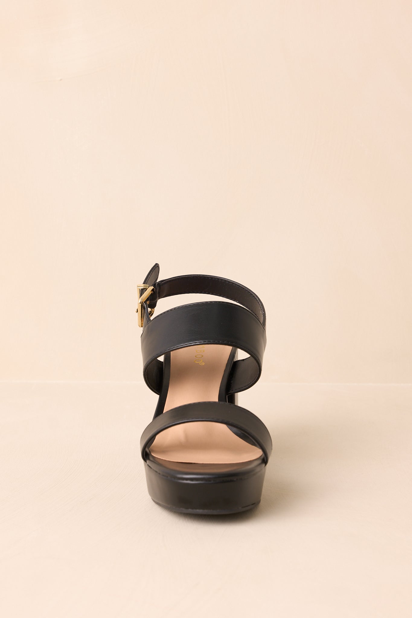 Black block heel sandals displayed at a front angle, showing the two wide straps across the foot.