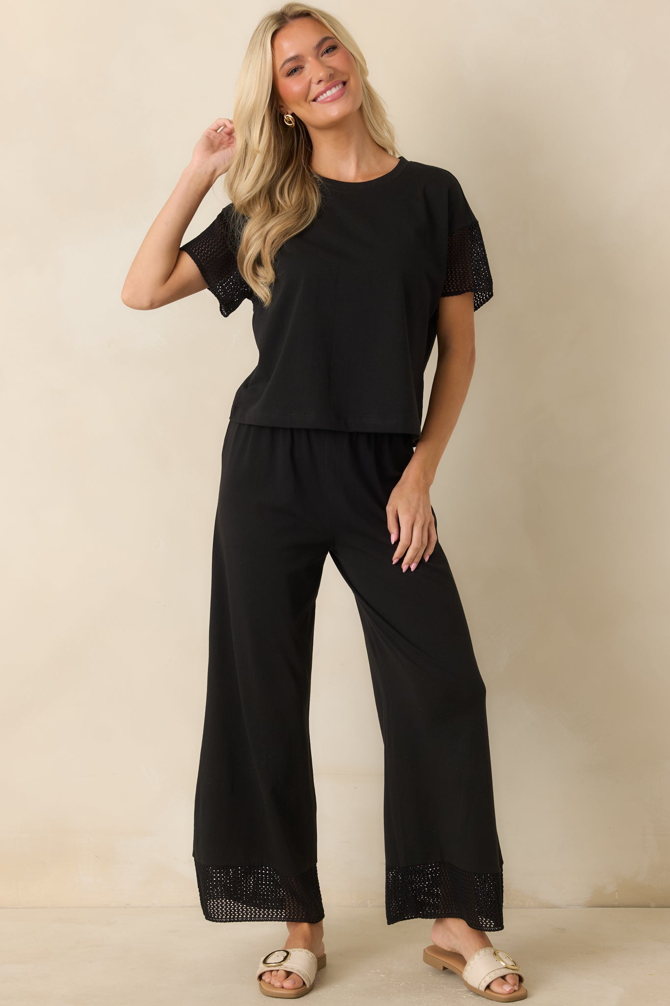 Black cotton and lyocell blend top featuring a boxy fit, short crochet-trimmed sleeves, and an easy cropped silhouette.