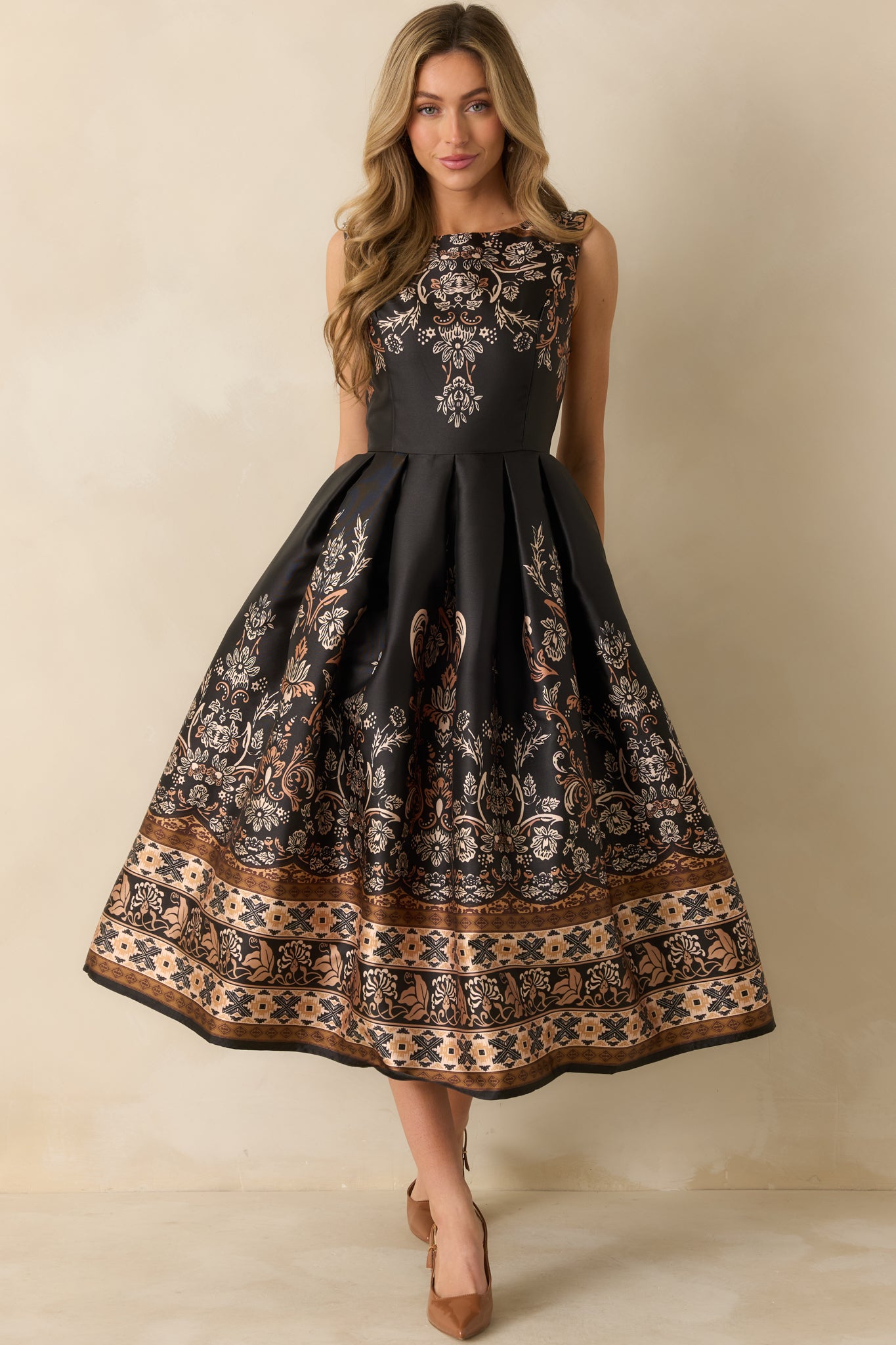 Front view of the black and bronze jacquard maxi dress with a sleeveless bodice and bateau neckline.