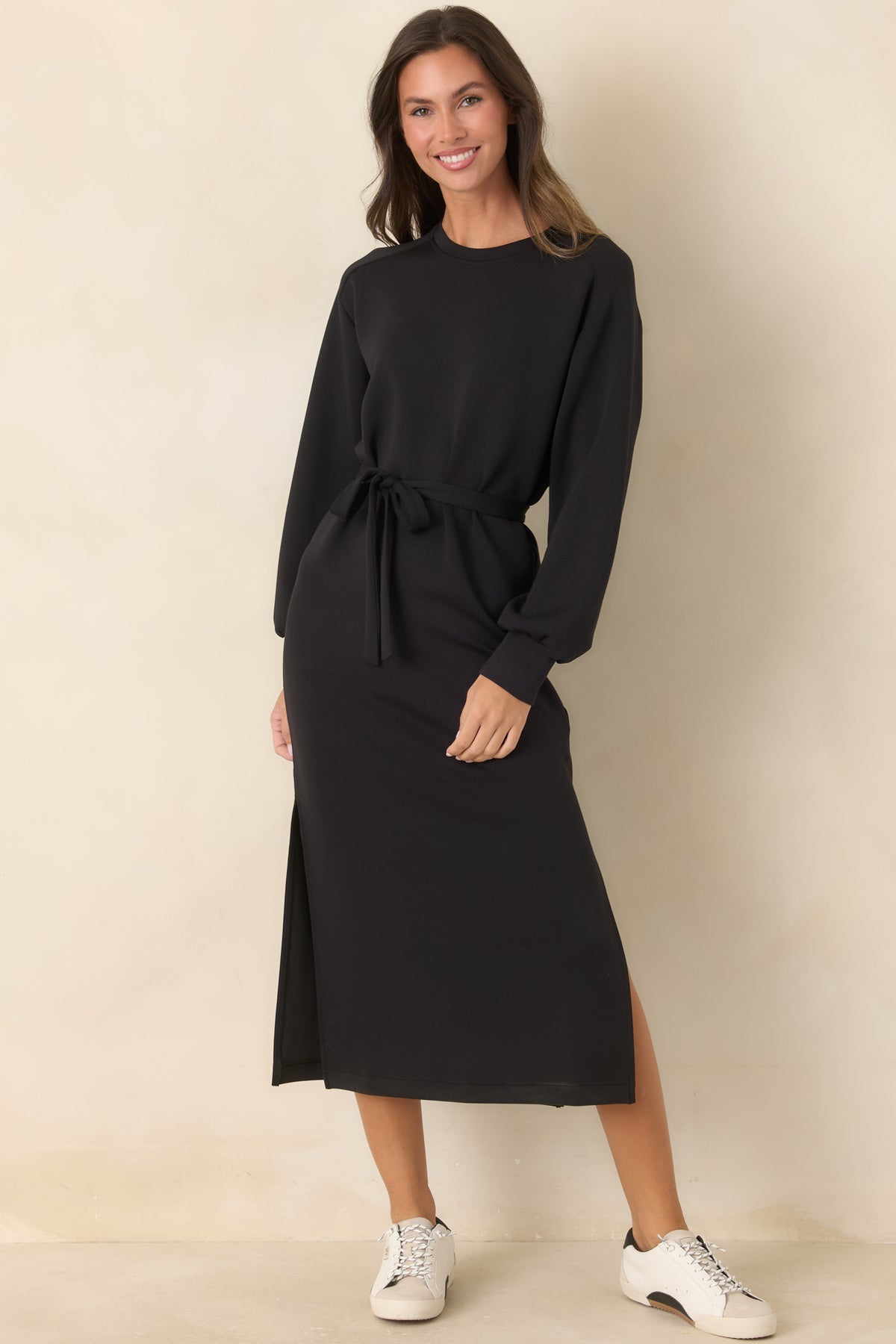Casual black midi dress with a matching waist tie and flowing skirt with side slits.