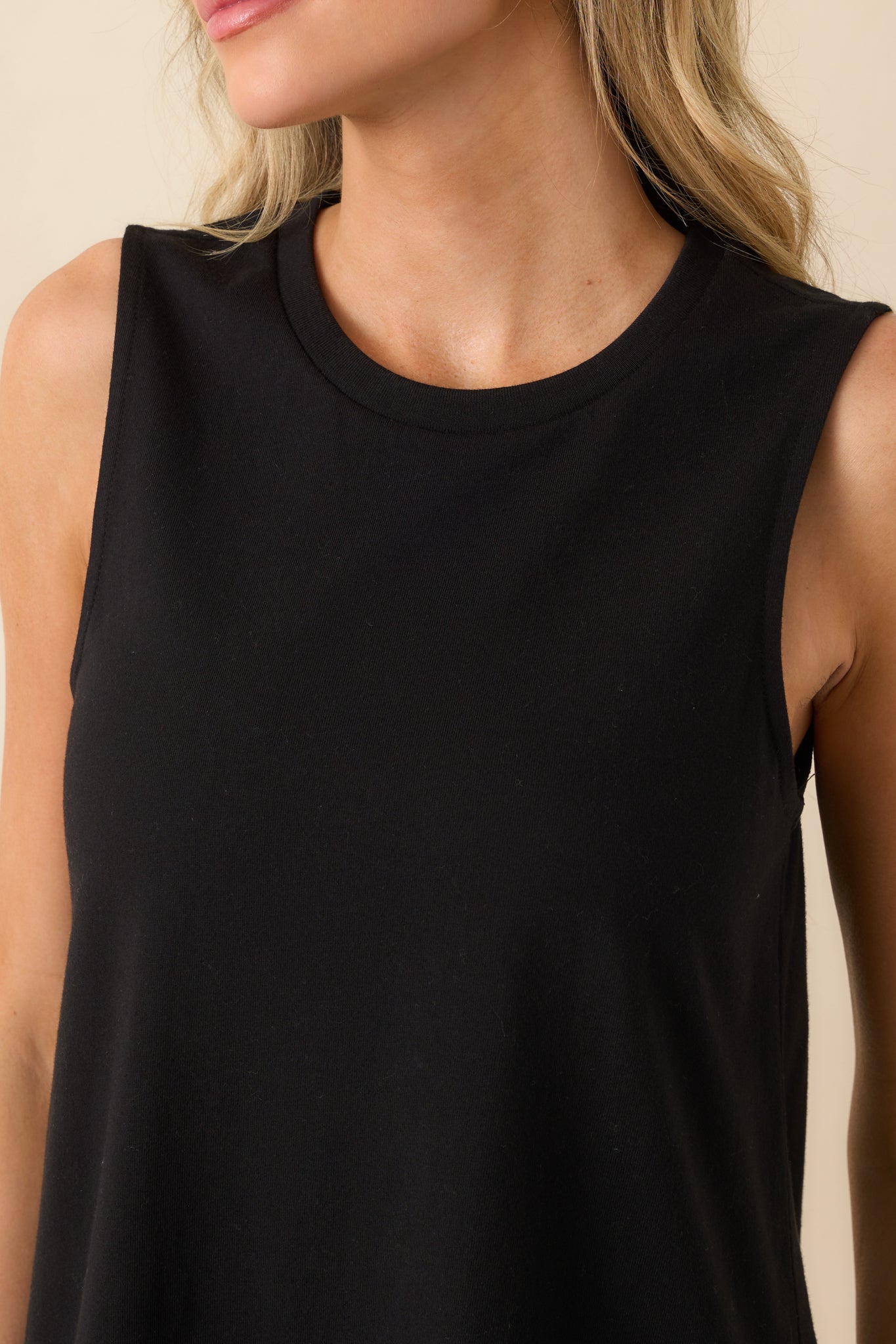 A detailed close-up of the neckline and upper chest area, showing the stitching and fabric texture.
