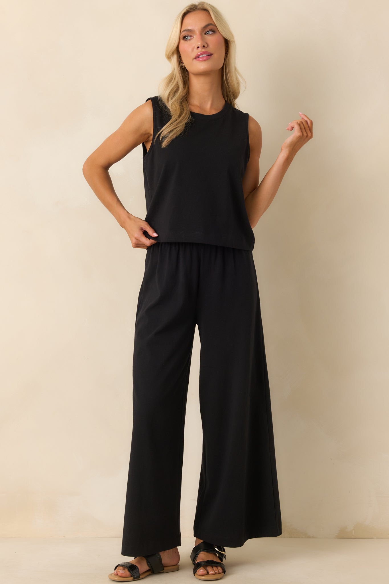 A full body image emphasizing the silhouette and drape of the wide legs from hip to hem.