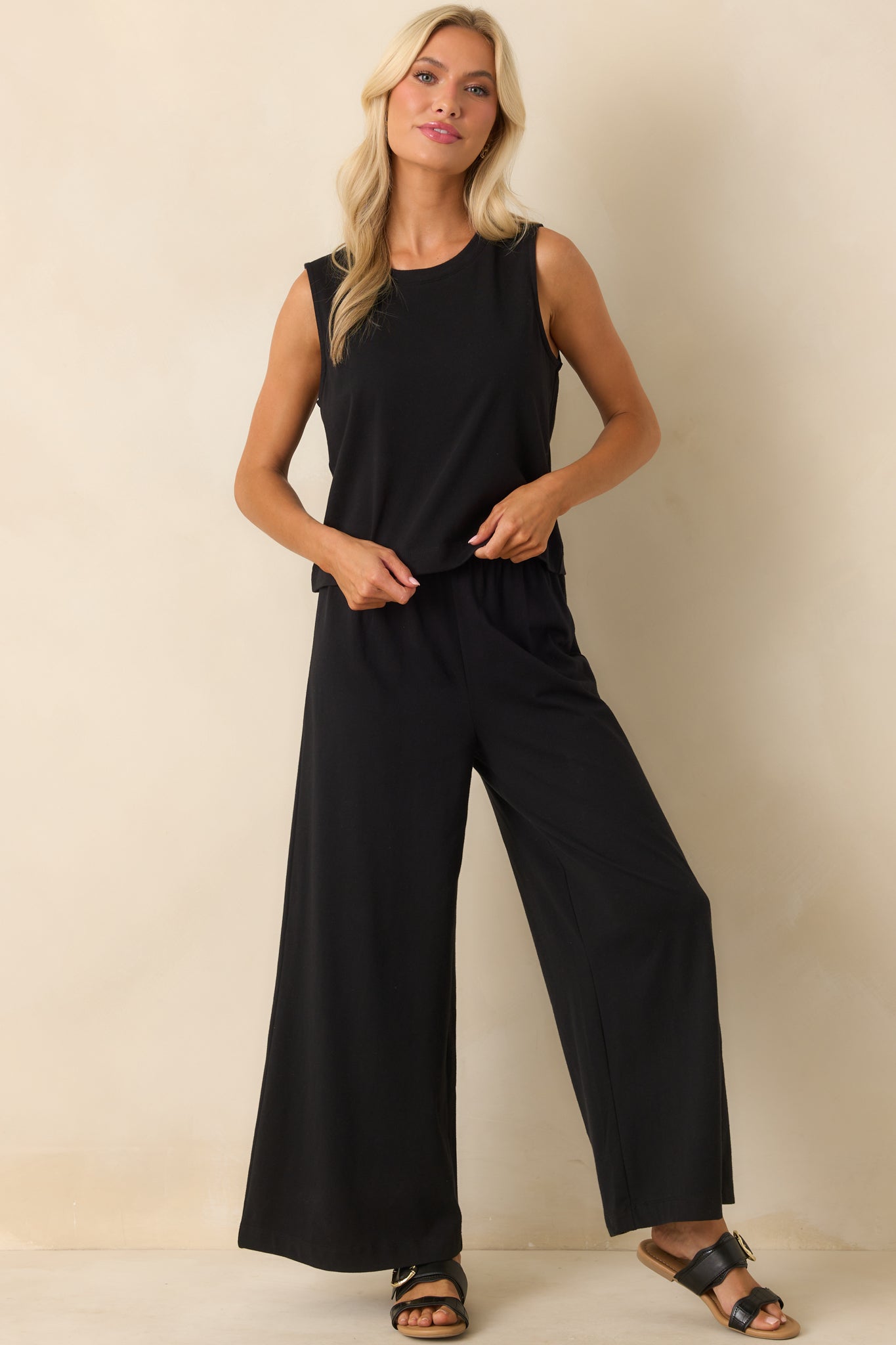 A full front view of the black pants showcasing the wide leg design and high waisted fit.