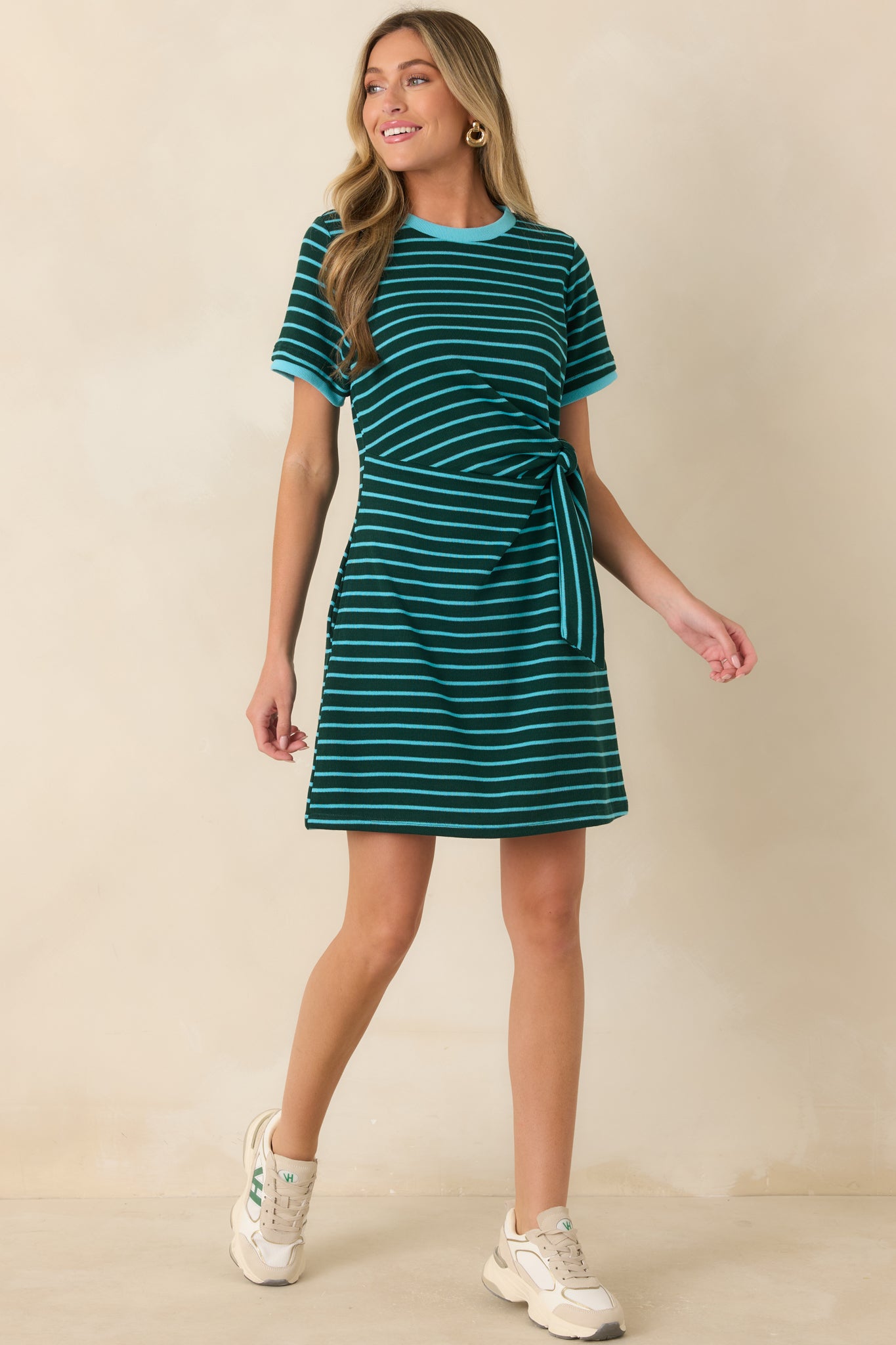 Comfortable black and cream mini dress featuring horizontal stripes, sporty contrast trim, and an easy fit ideal for everyday wear.