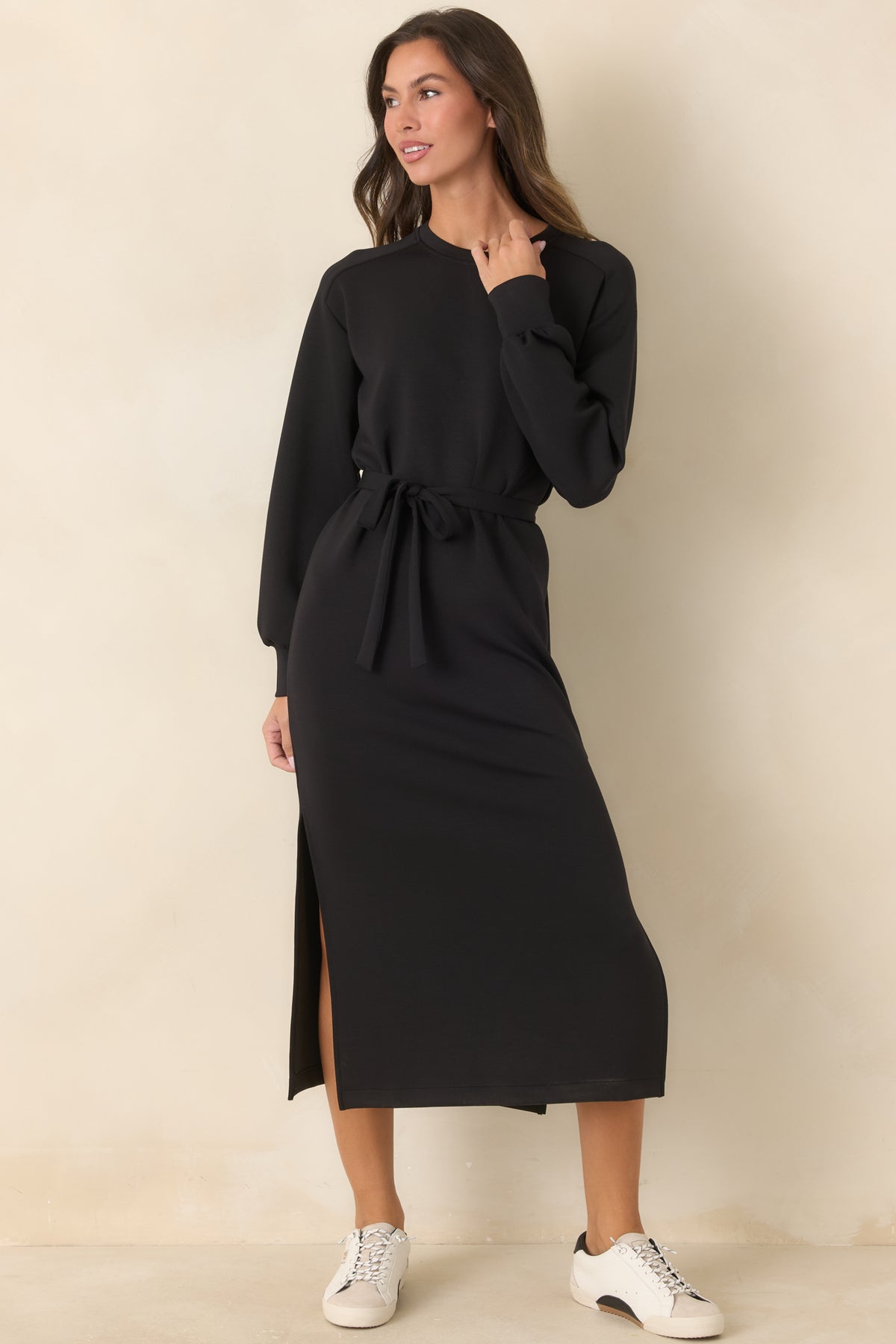 Black crew-neck dress showcasing the sporty banded cuffs and gently defined waist.