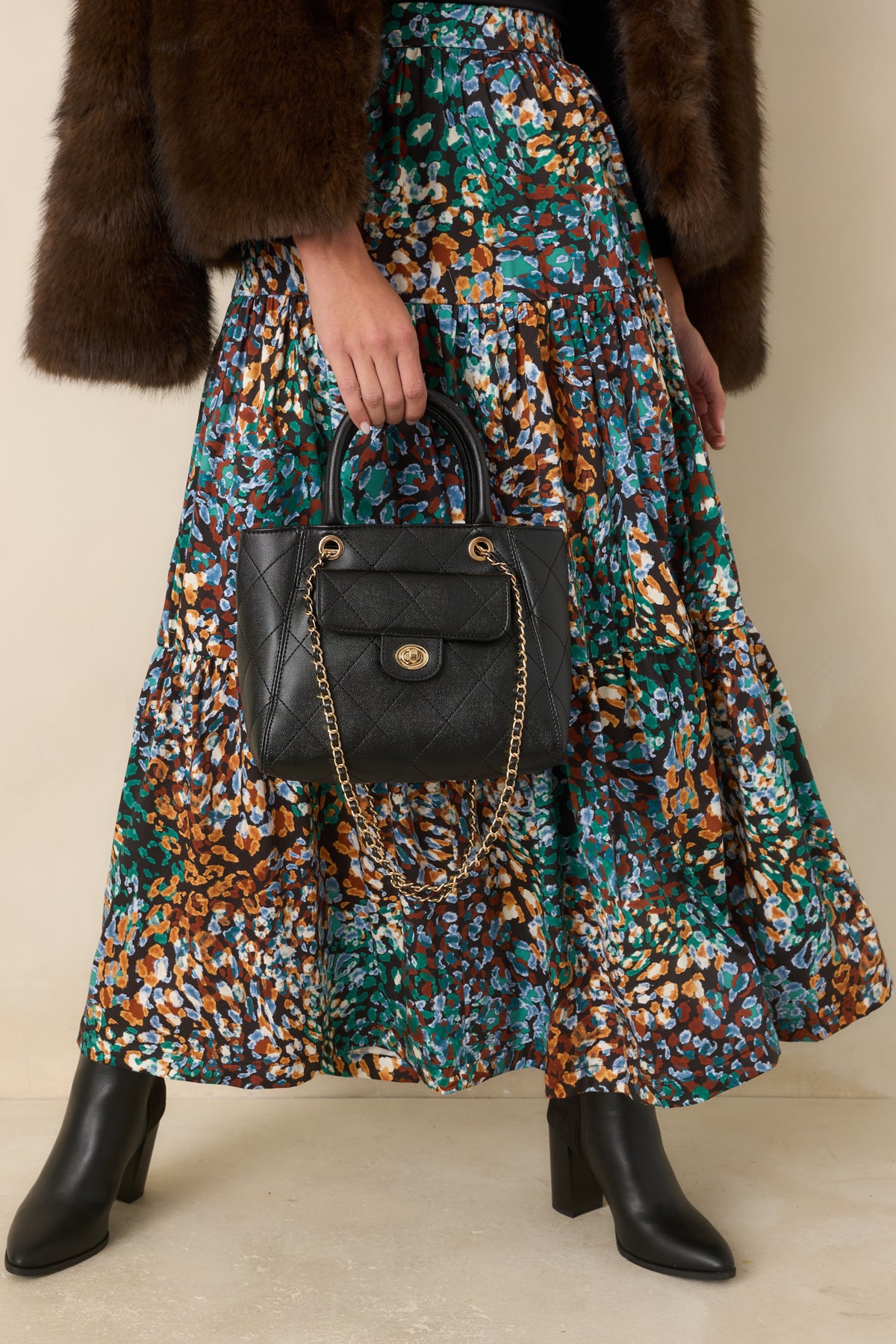 Everyday black handbag with a separate twist-lock front pocket and diamond quilting.